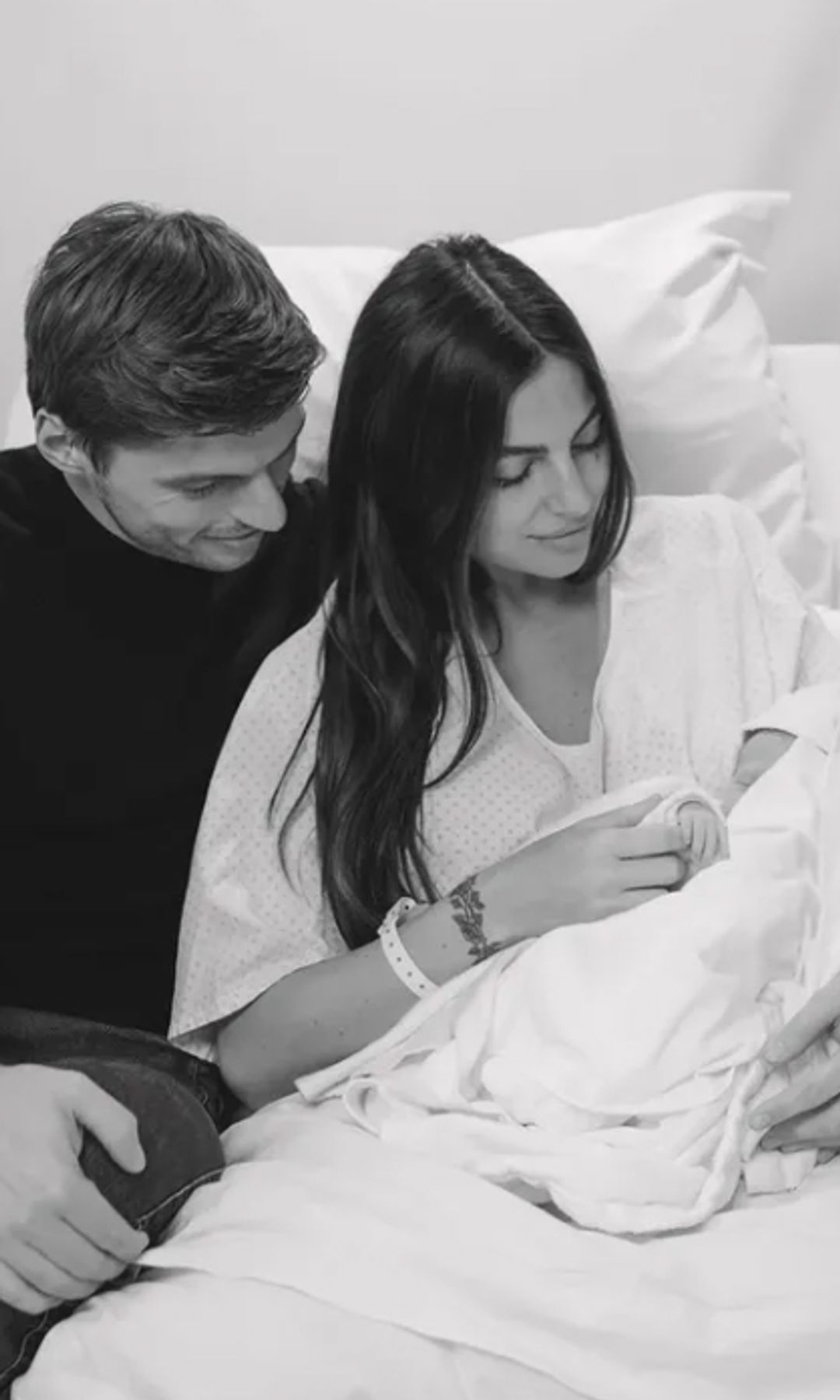Black-and-white photo of Max Verstappen and Kelly Piquet with their baby