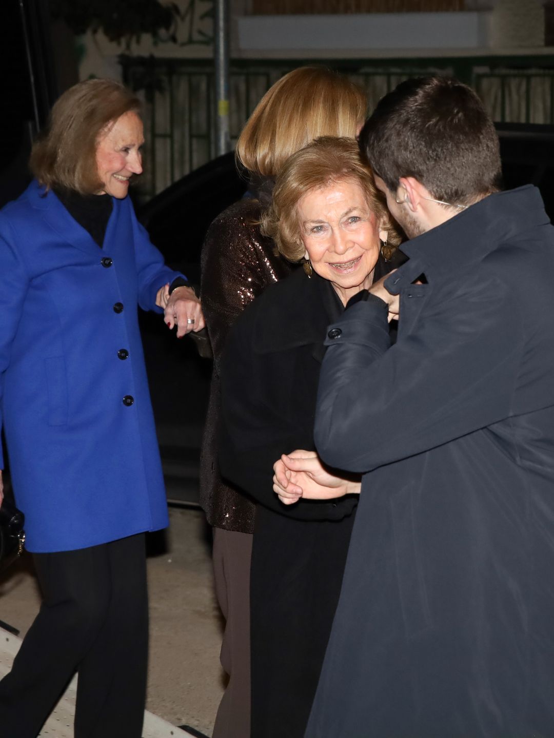 Queen Sofia smiling with a group of people