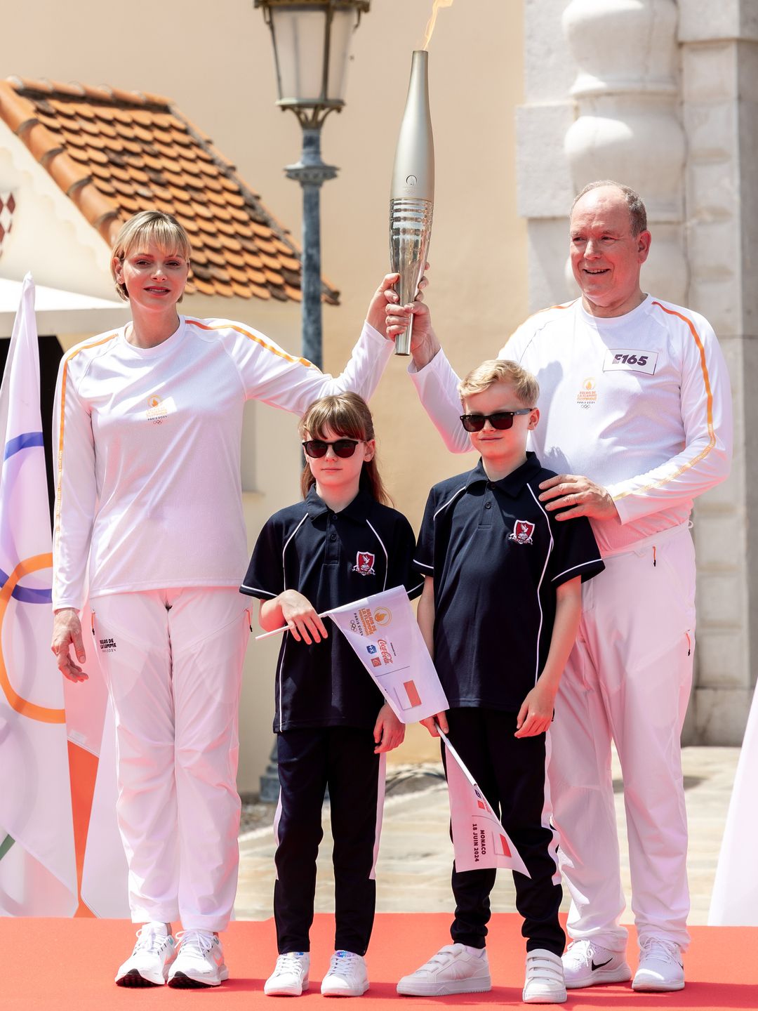 monaco royals holding olympic torch