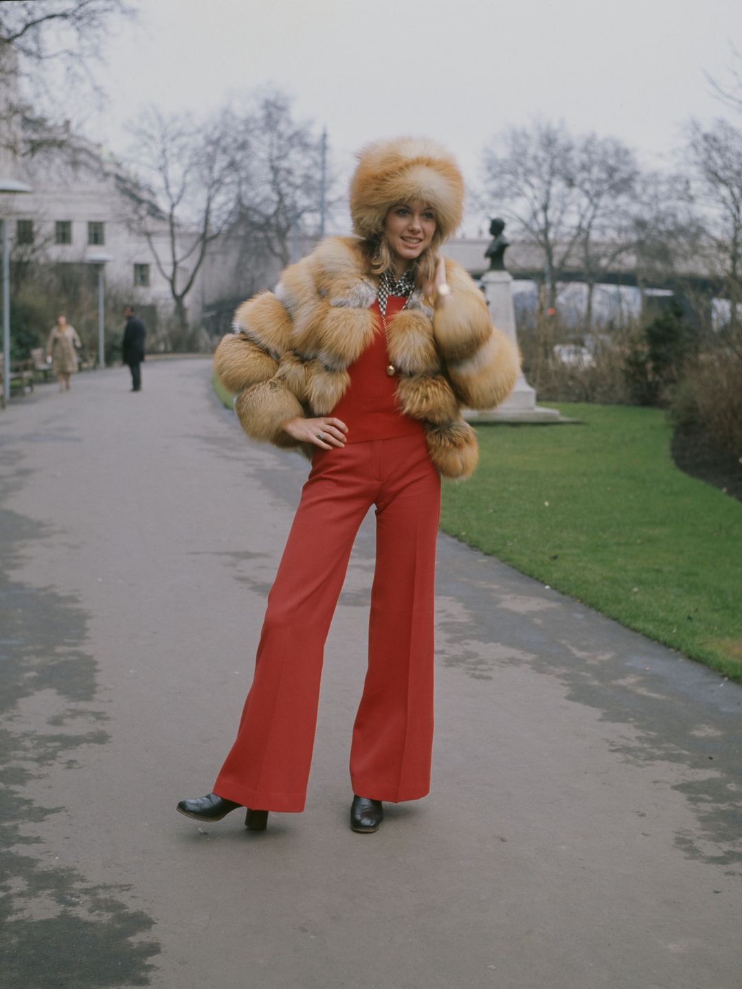 English-Australian singer, Olivia Newton-John wearing a fur hat and jacket, outside the Savoy Hotel in London, circa 1970