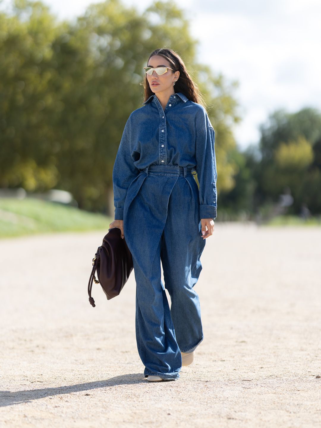 Tamara Kalinic wearing a denim jumpsuit outside the Loewe show in Paris. 