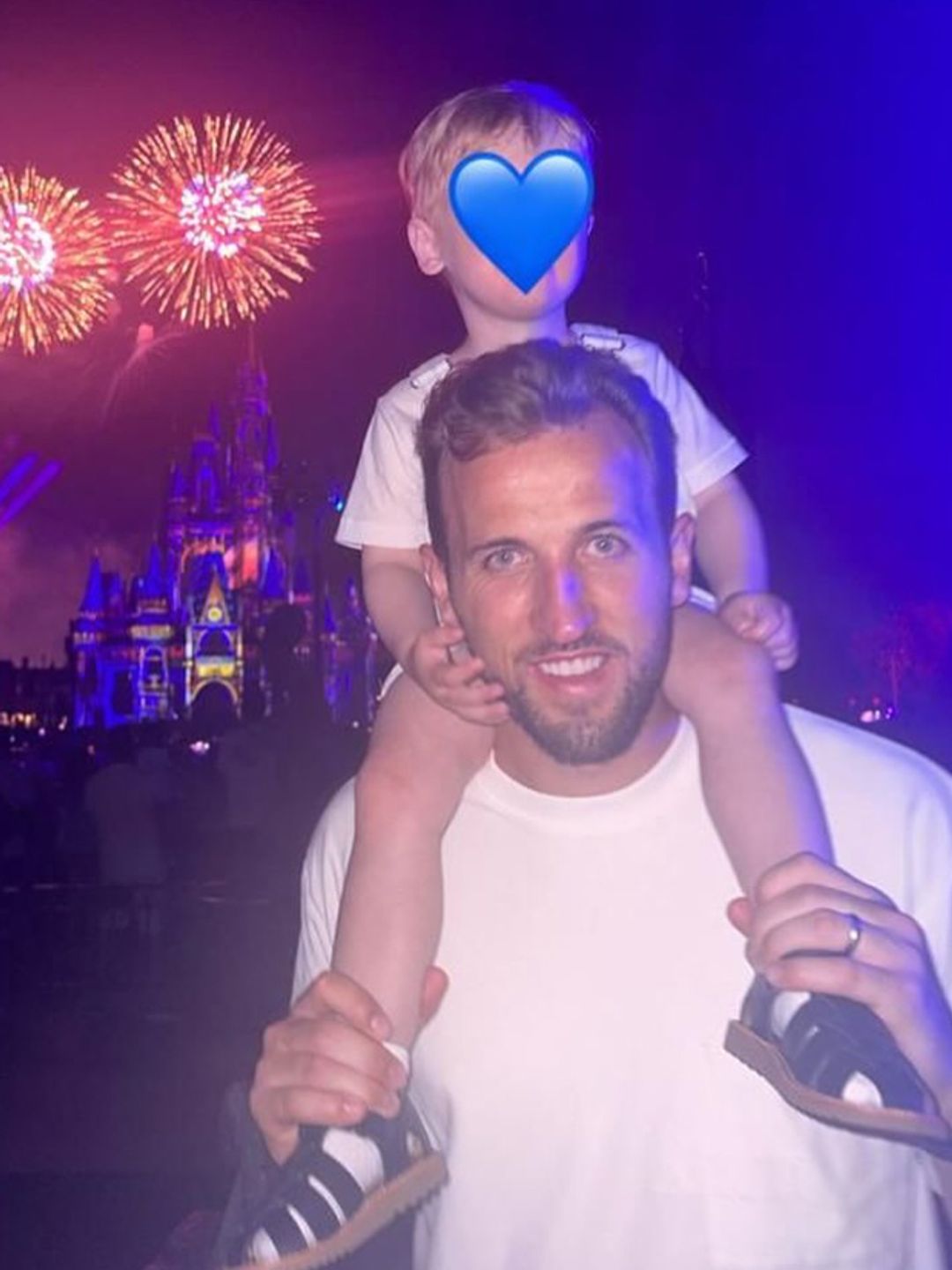 Harry Kane at Disneyland fireworks with a young boy on his shoulders