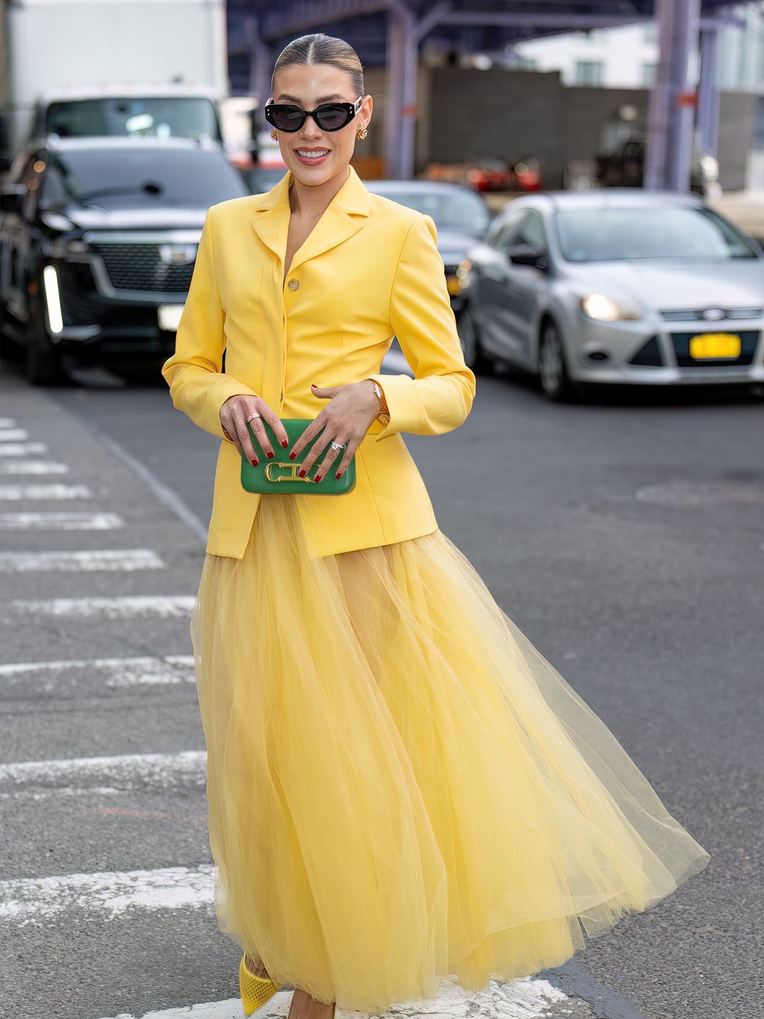 Michelle Salas is seen arriving to the Carolina Herrera fashion show in a yellow tulle skirt, yellow blazer and yellow heels