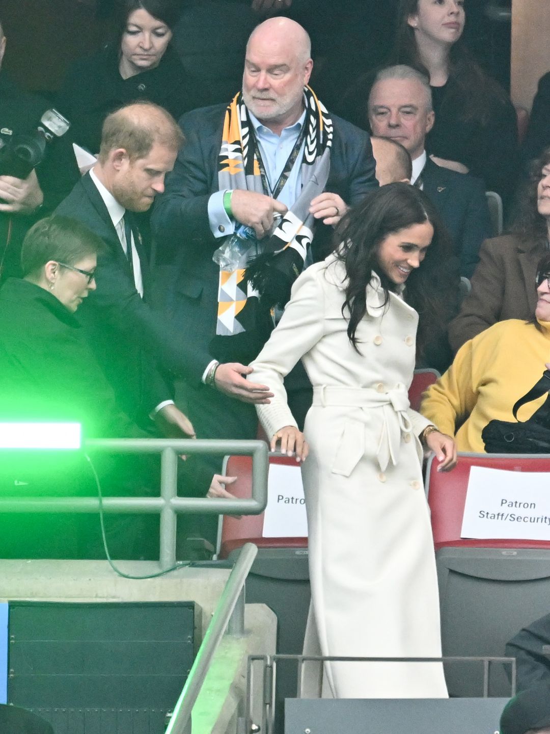 Meghan Markle holding Prince Harry's hand