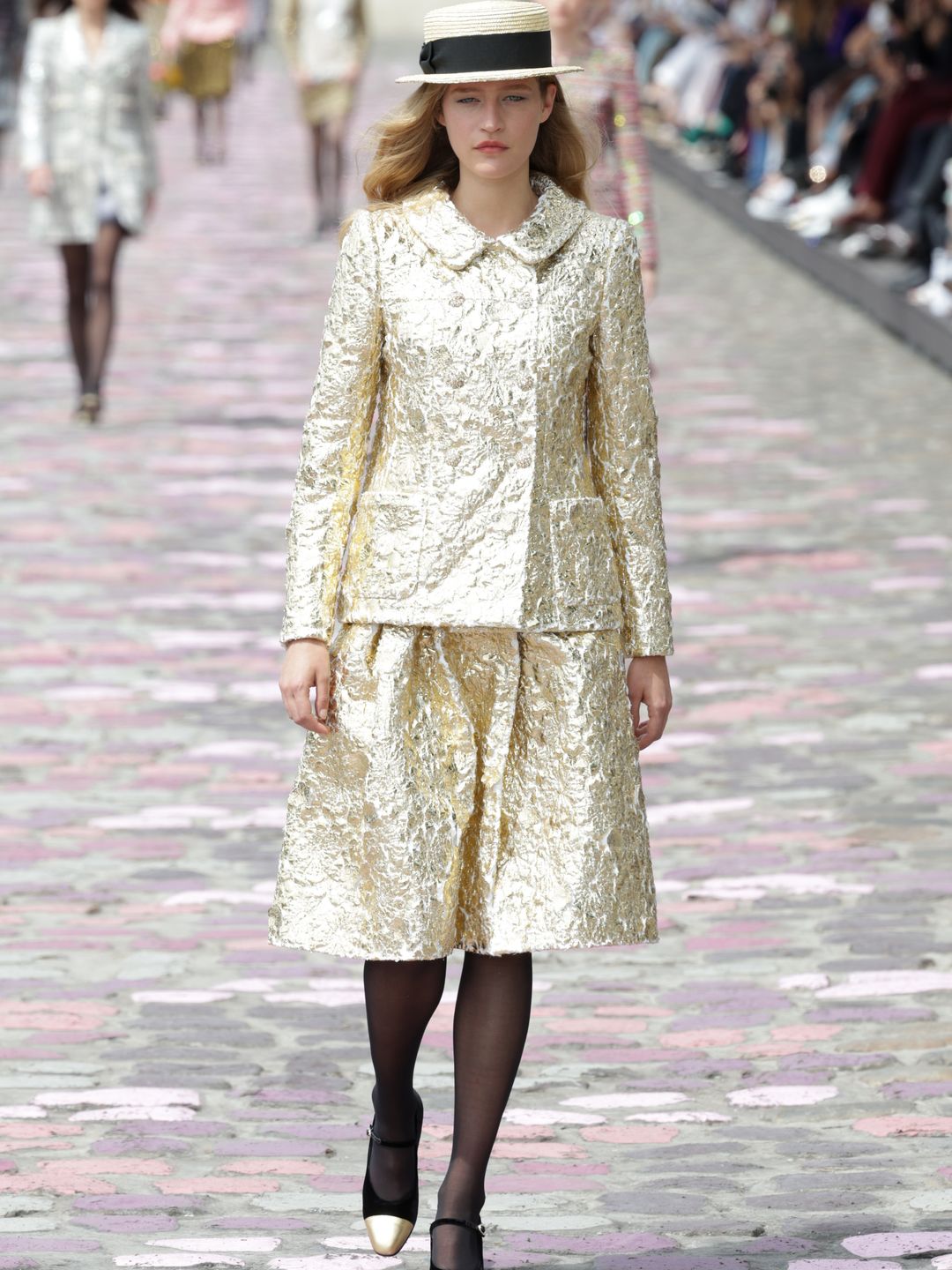 Chanel model wearing gold jacquard outfit 