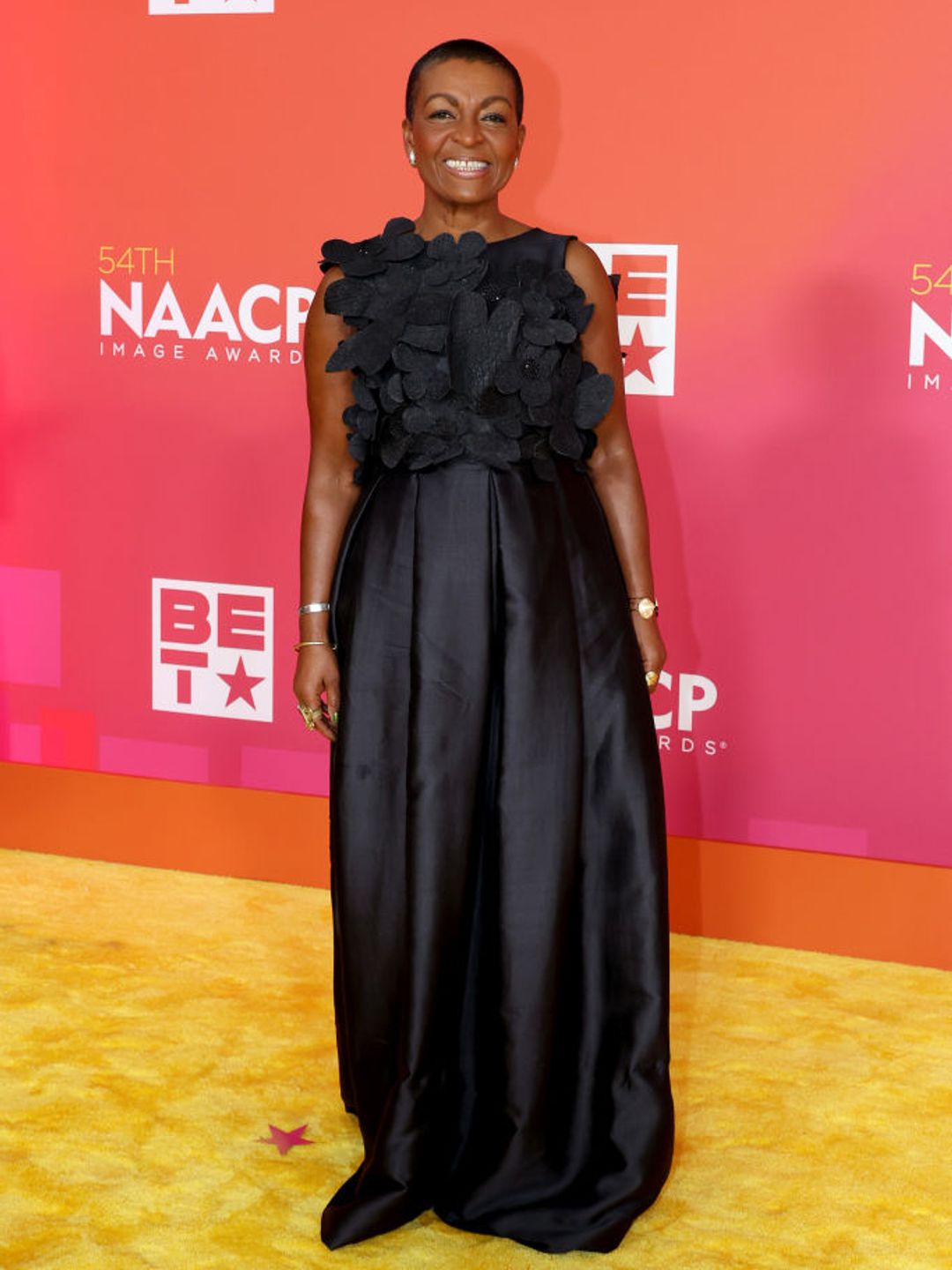 Adjoa attends the 54th NAACP Image Awards. She is wearing a black satin dress. 