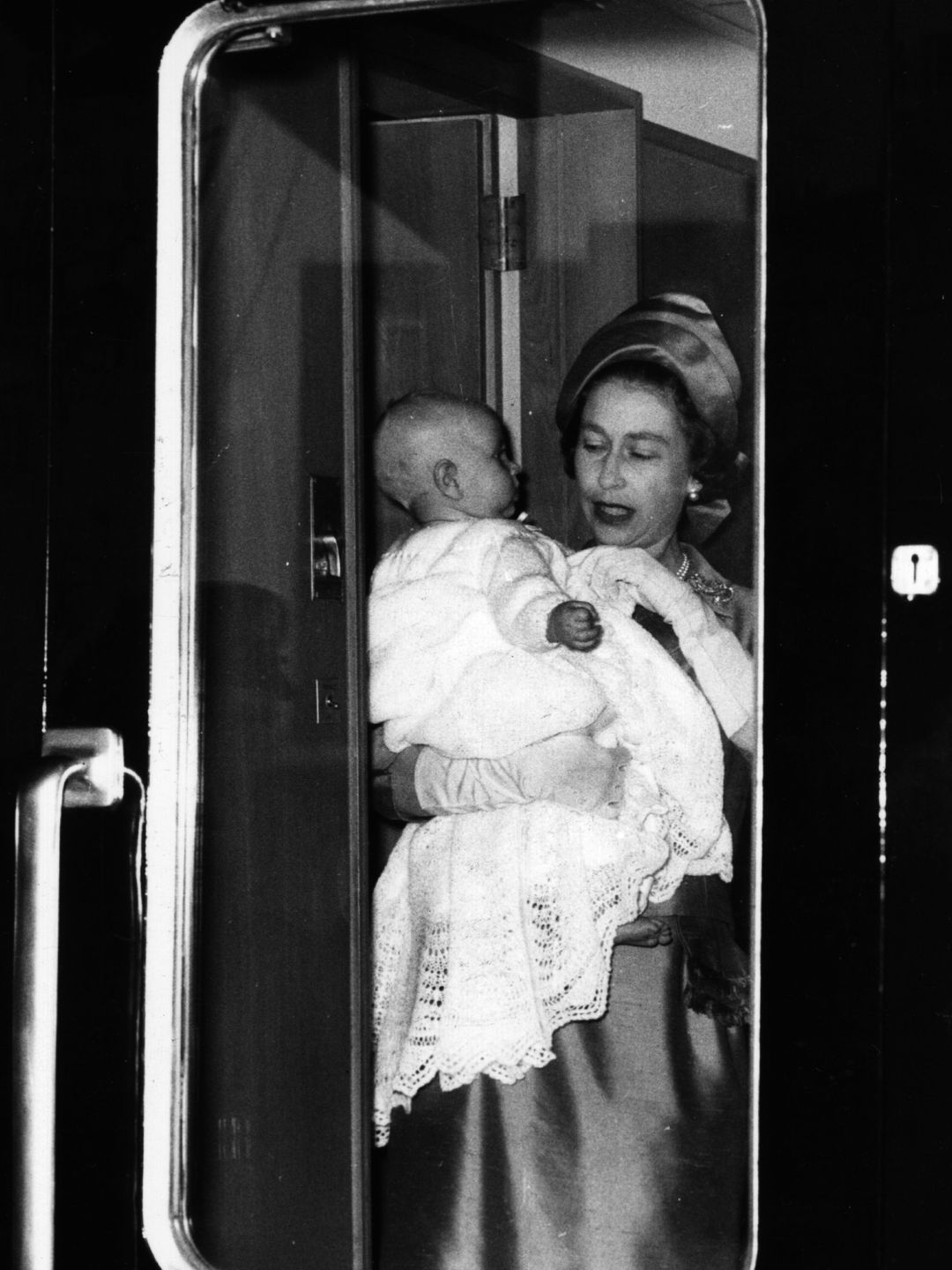 The Queen holding a baby Prince Edward
