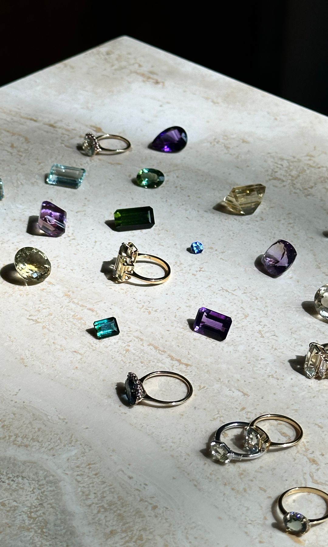 rings and gem stones on a marble slab