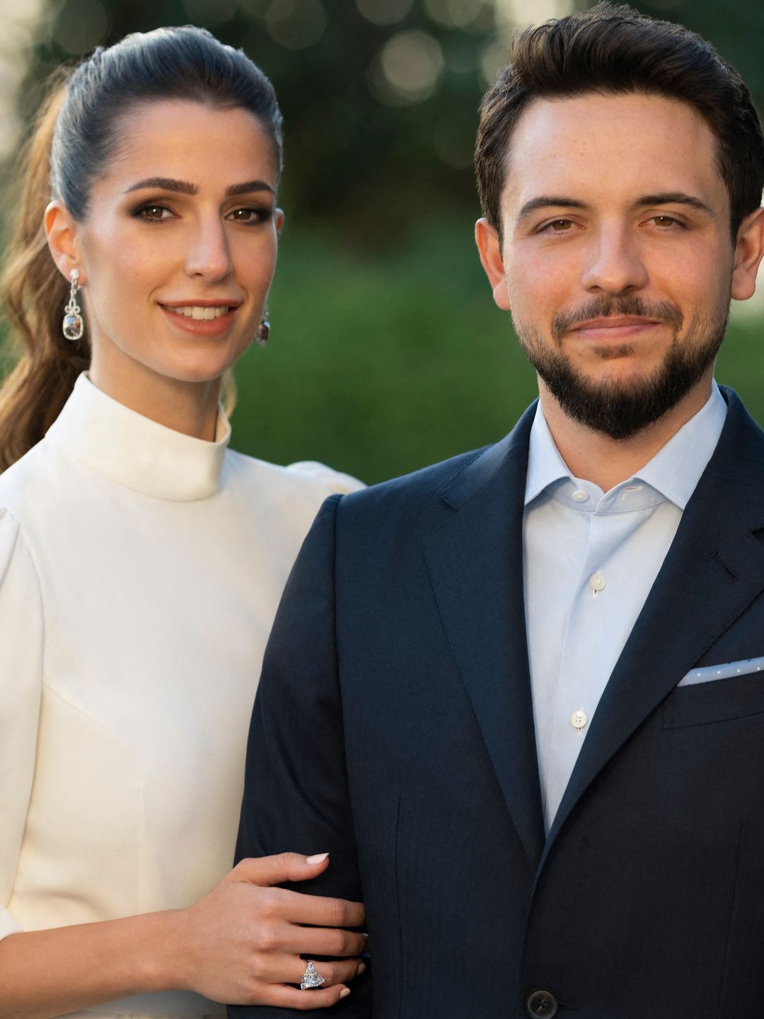 Jordan's Crown Prince Hussein in a suit with his fiancee Rajwa Al Saif wearing a white dress