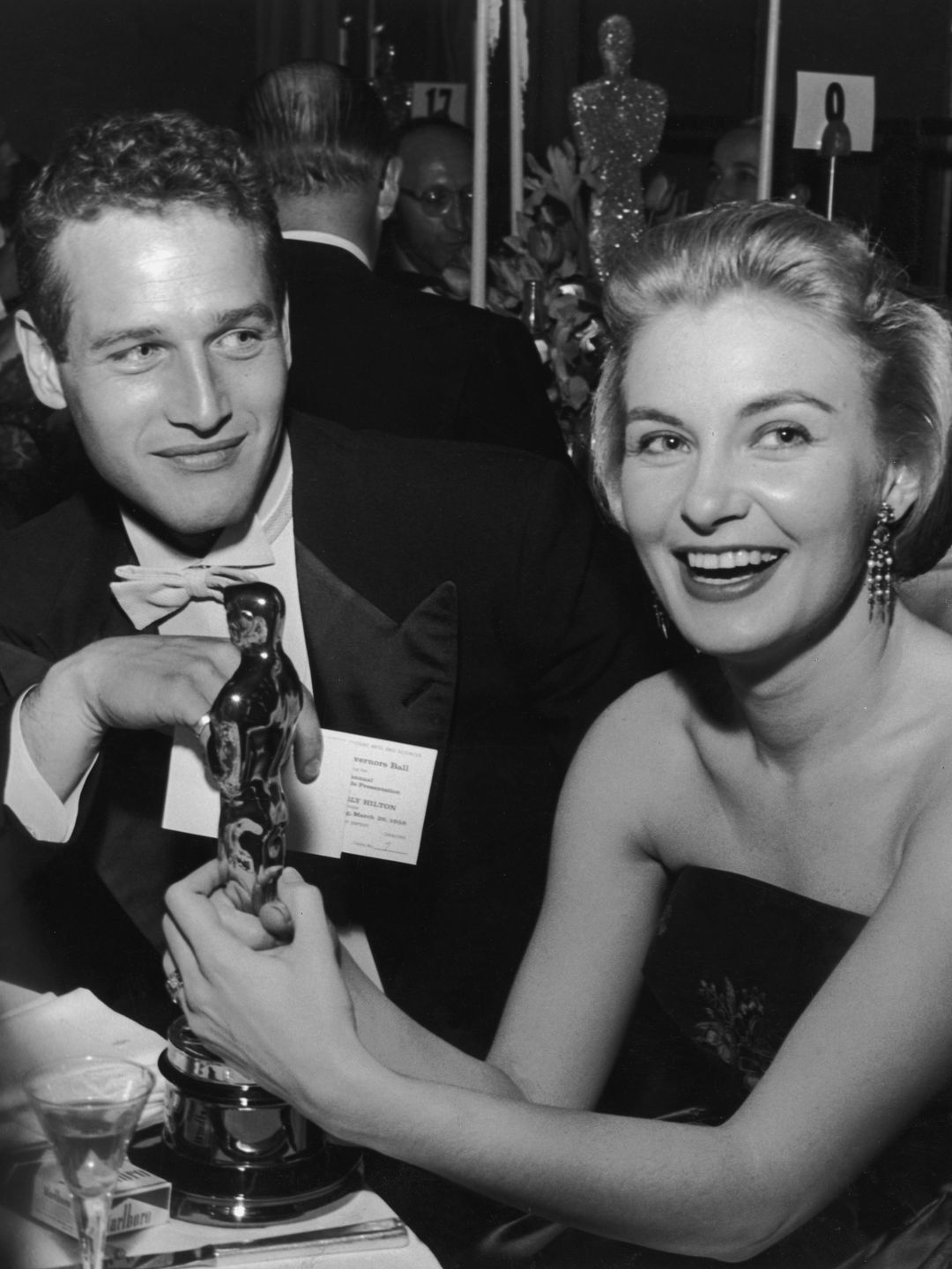American actor Joanne Woodward holding award next to husband Paul Newman