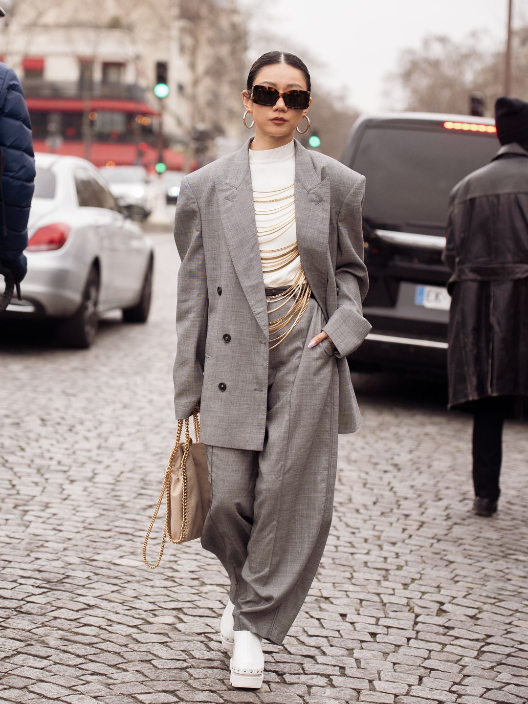 A stylish guest wearing a white turtleneck at Paris Fashion Week AW23-24