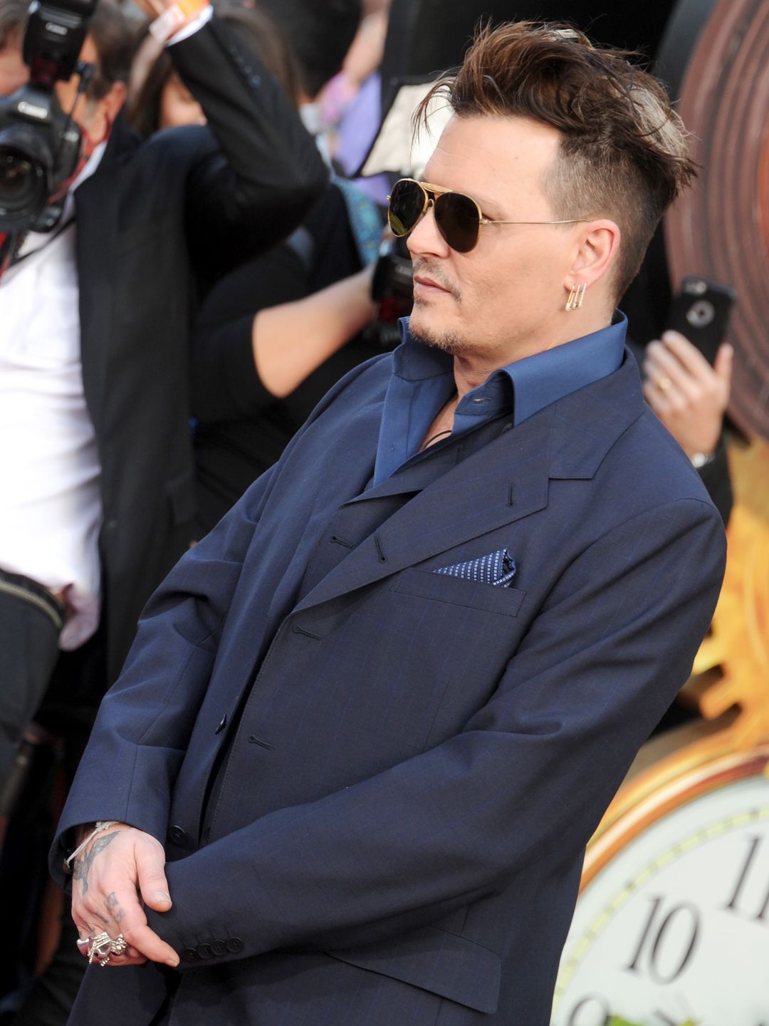 Johnny at the premiere for Alice Through The Looking Glass in a blue suit and wearing sunglasses