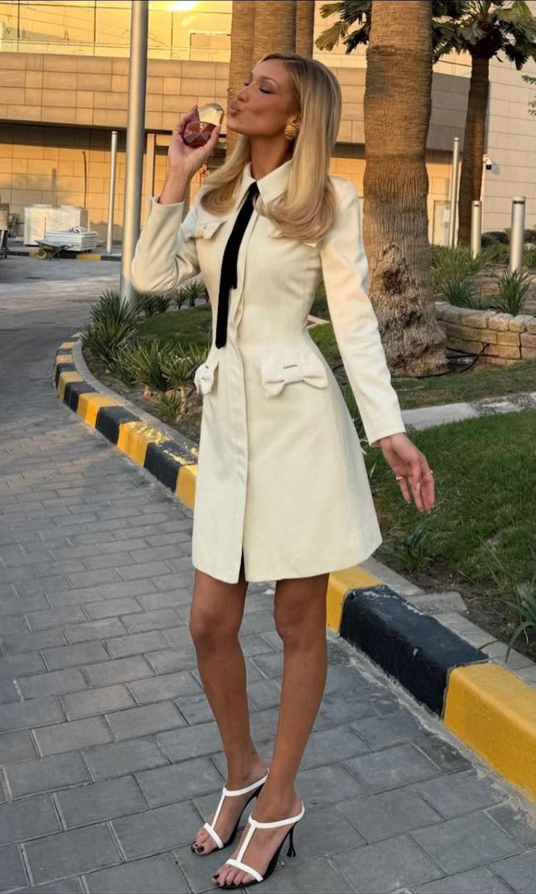 Bella Hadid poses in a white dress 