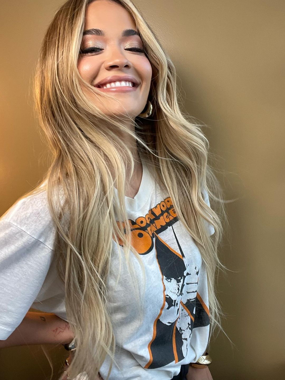 Rita Ora shares a smiling picture of her in a graphic tee 