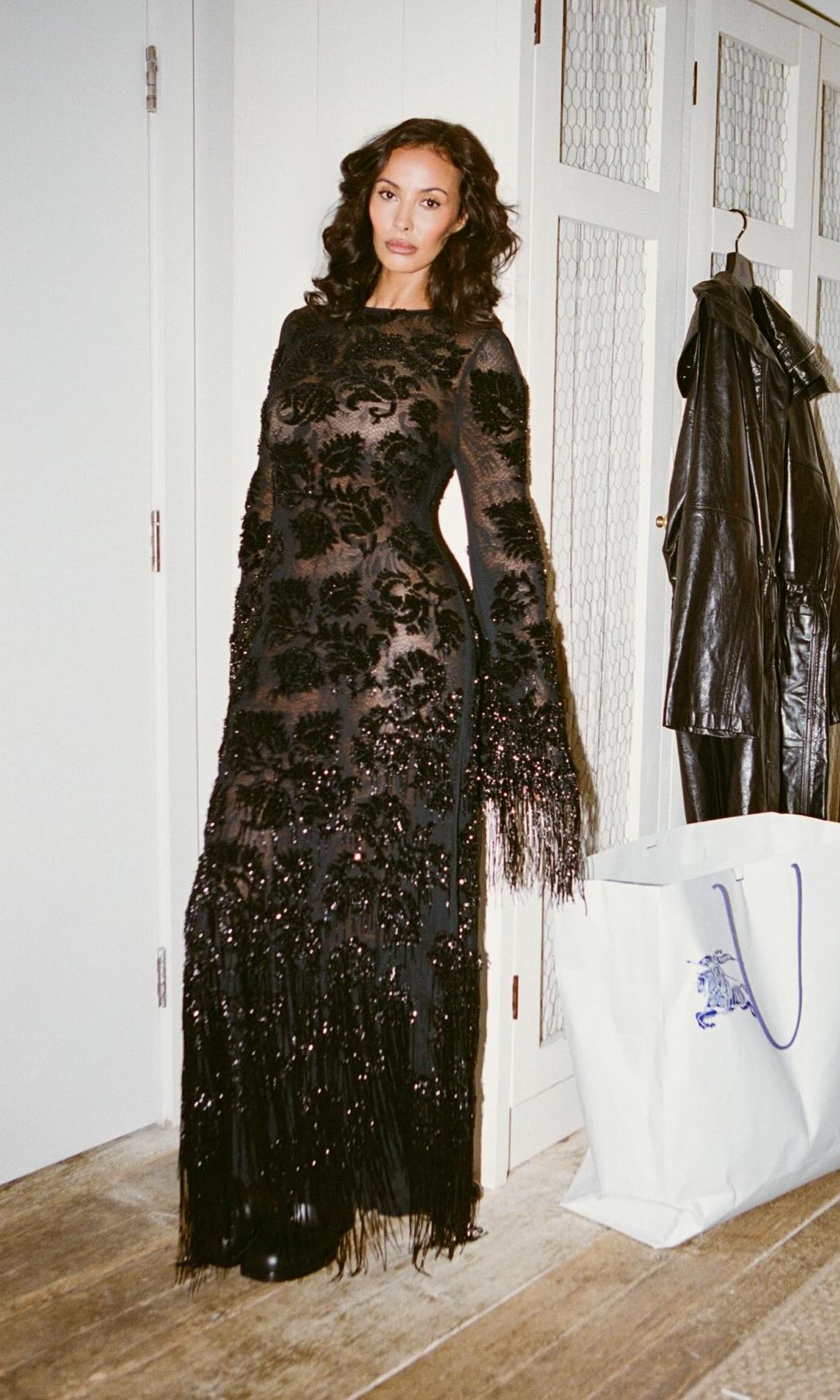 Maya Jama poses in a room wearing a lace dress from Burberry