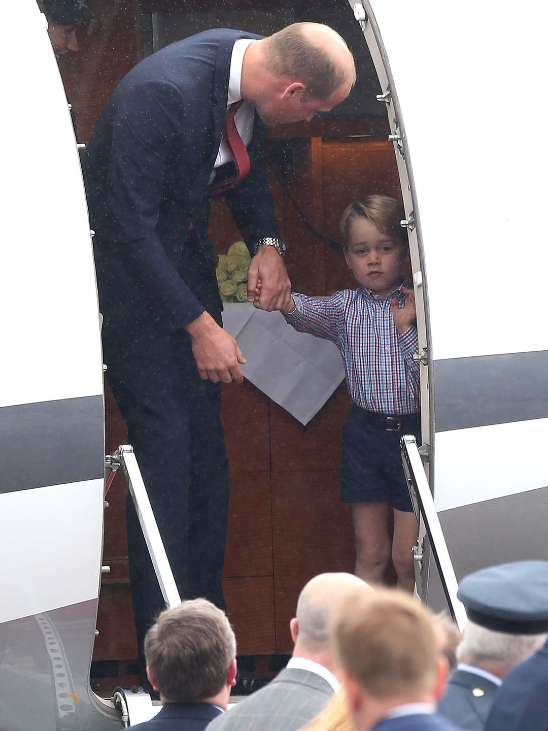 Prince William and a young Prince George in an aeroplane door