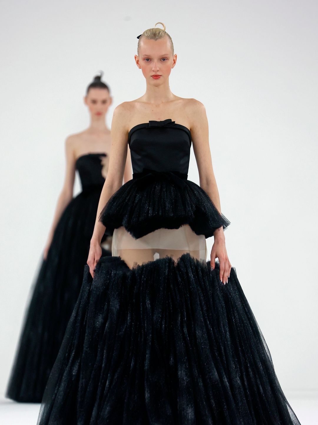  A model walks the runway during the Viktor & Rolf Haute Couture Spring/Summer show in a. black strapless gown