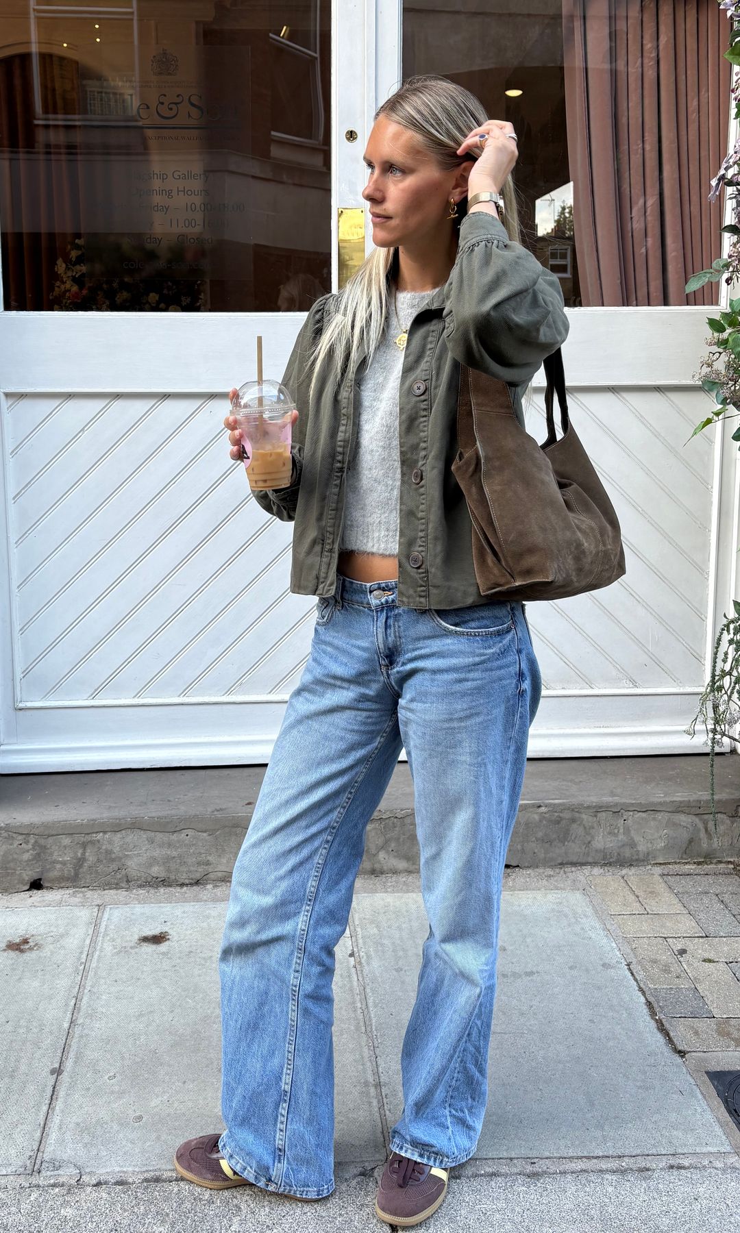 blonde girl in jeans and kahki jacket