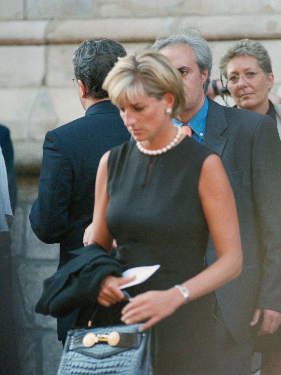 Diana, Princess of Wales at the last tribute to Gianni Versace at Milan Cathedral carrying her 'Diana' handbag