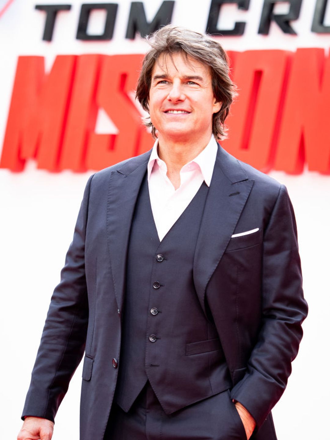 Tom Cruise smiling on the red carpet for Mission Impossible 7