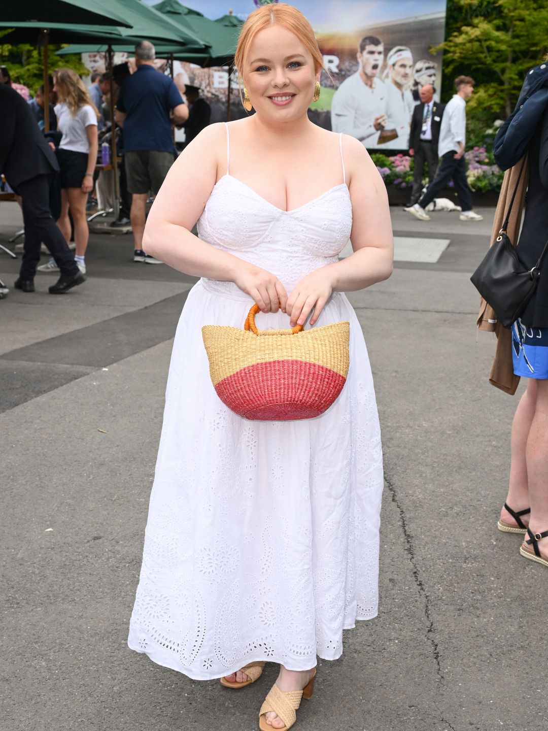 Nicola Coughlan wearing a white broderie anglaise sleeveless dress and raffia mules 