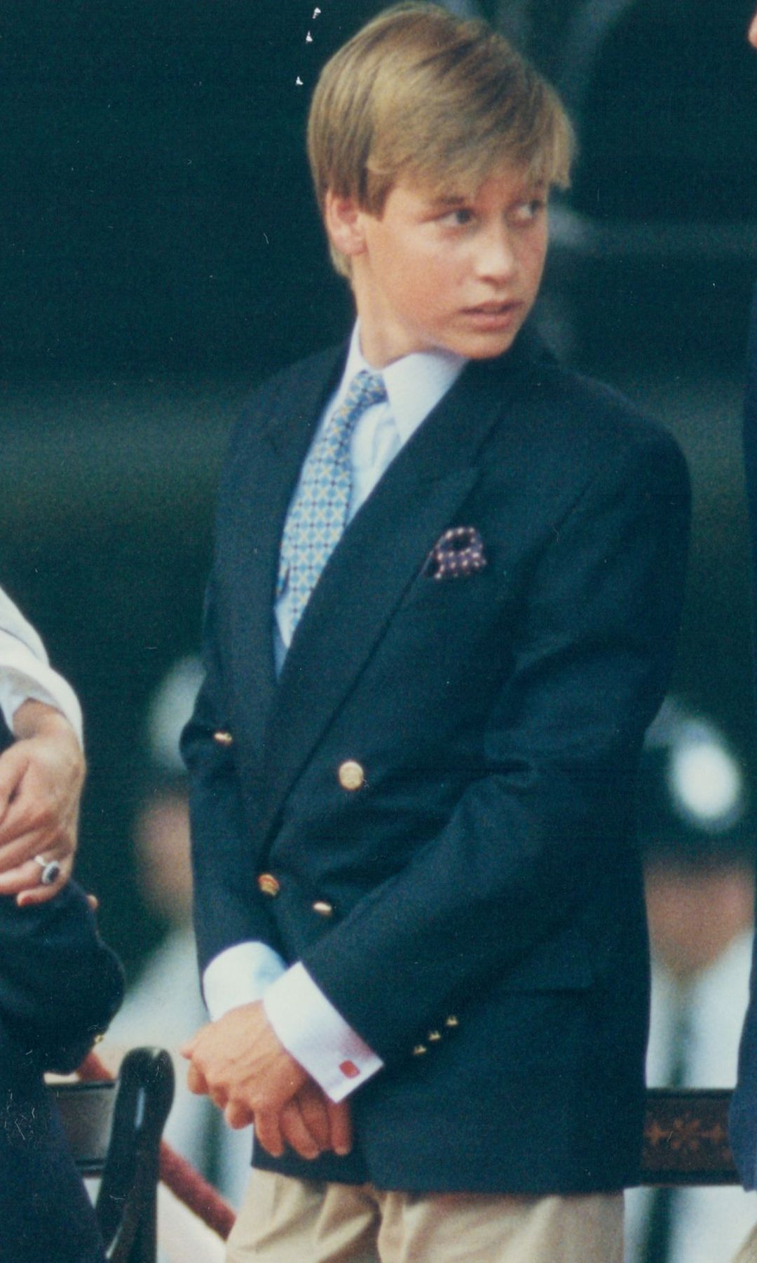 Prince William clasping his hands in a blue jacket in 1995