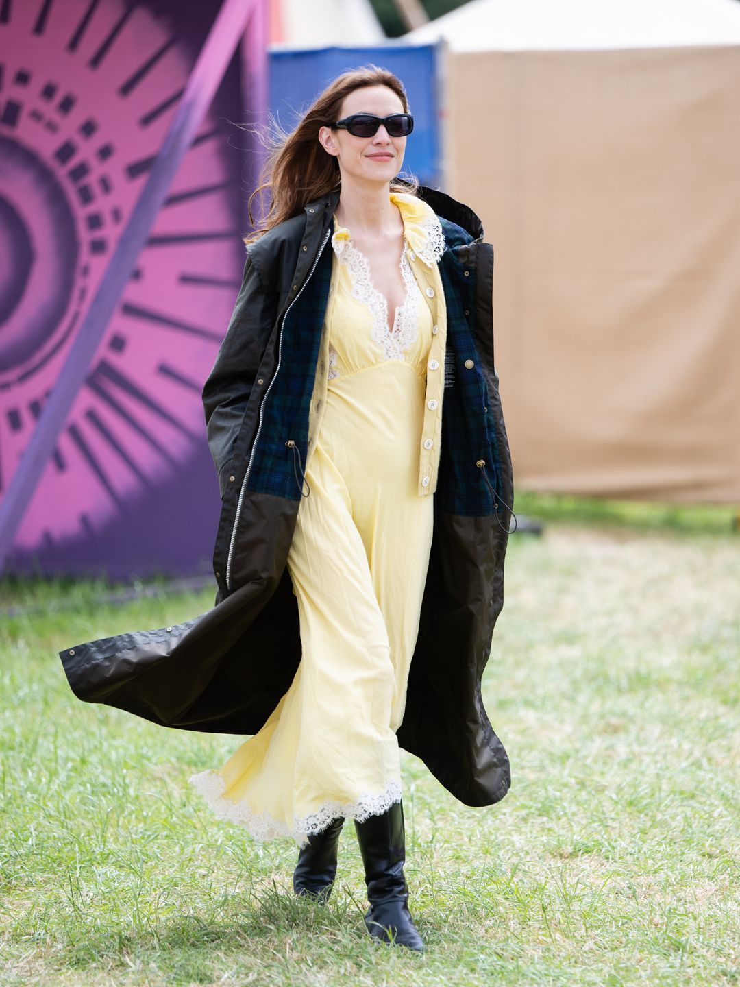 Alexa Chung during day three of Glastonbury in a yellow slip dress and a jacket from her Barbour collaboration.