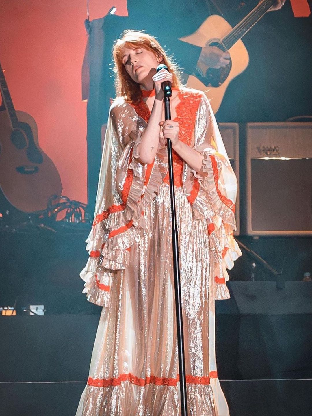 Florence Welch onstage performing in a shimmering gown