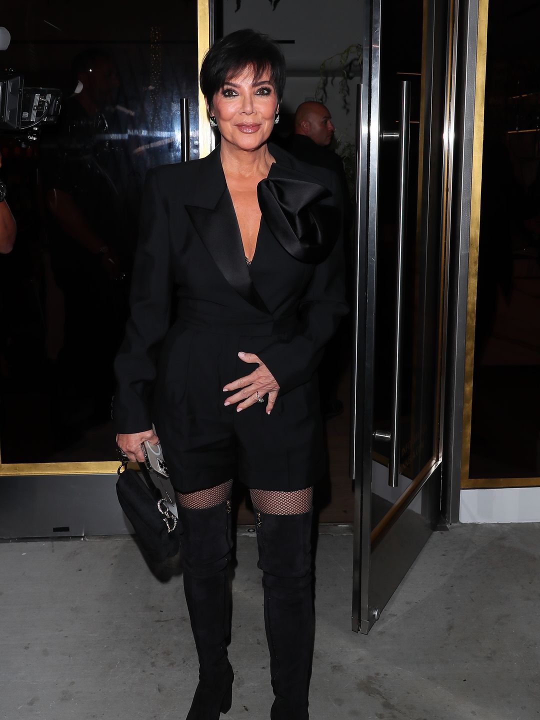 Mom-ager Kris steps out in an all black ensemble paired with a diamond adorned Dior saddle bag to celebrate 