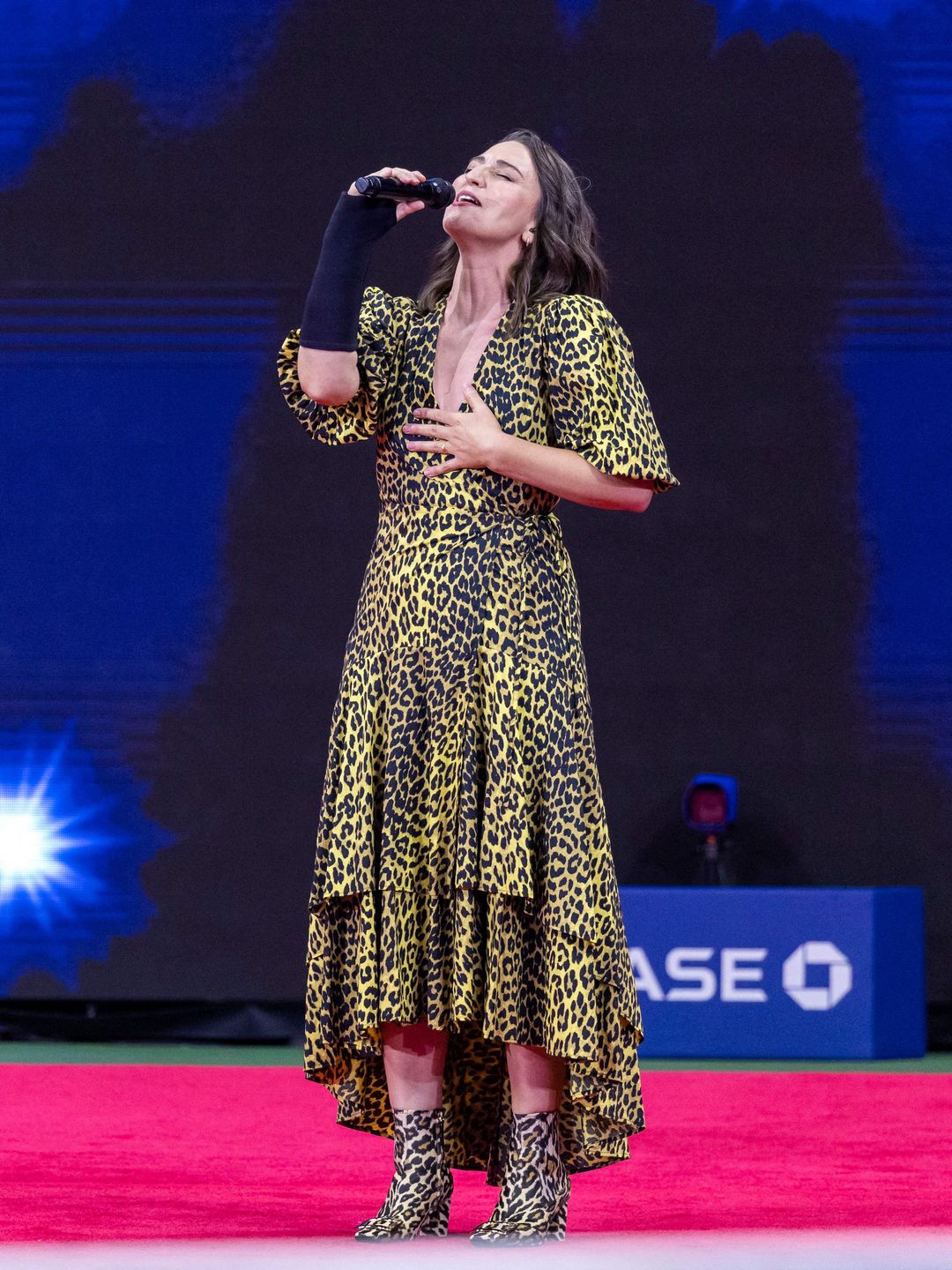 Singer Sara Bareilles performing in leopard print dress at the US Open 