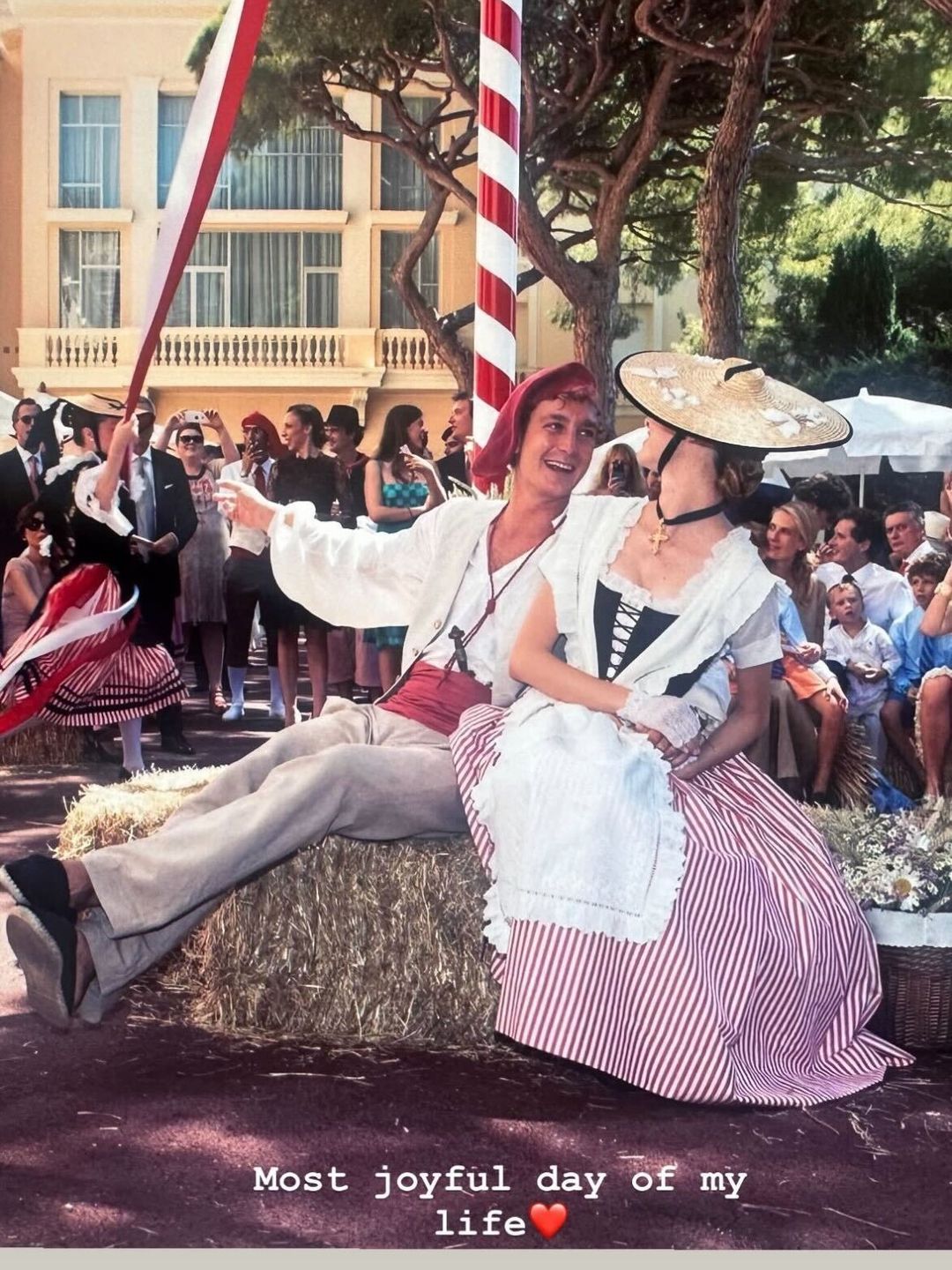 Pierre Casiraghi and his wife Beatrice in regional dress on a haystack