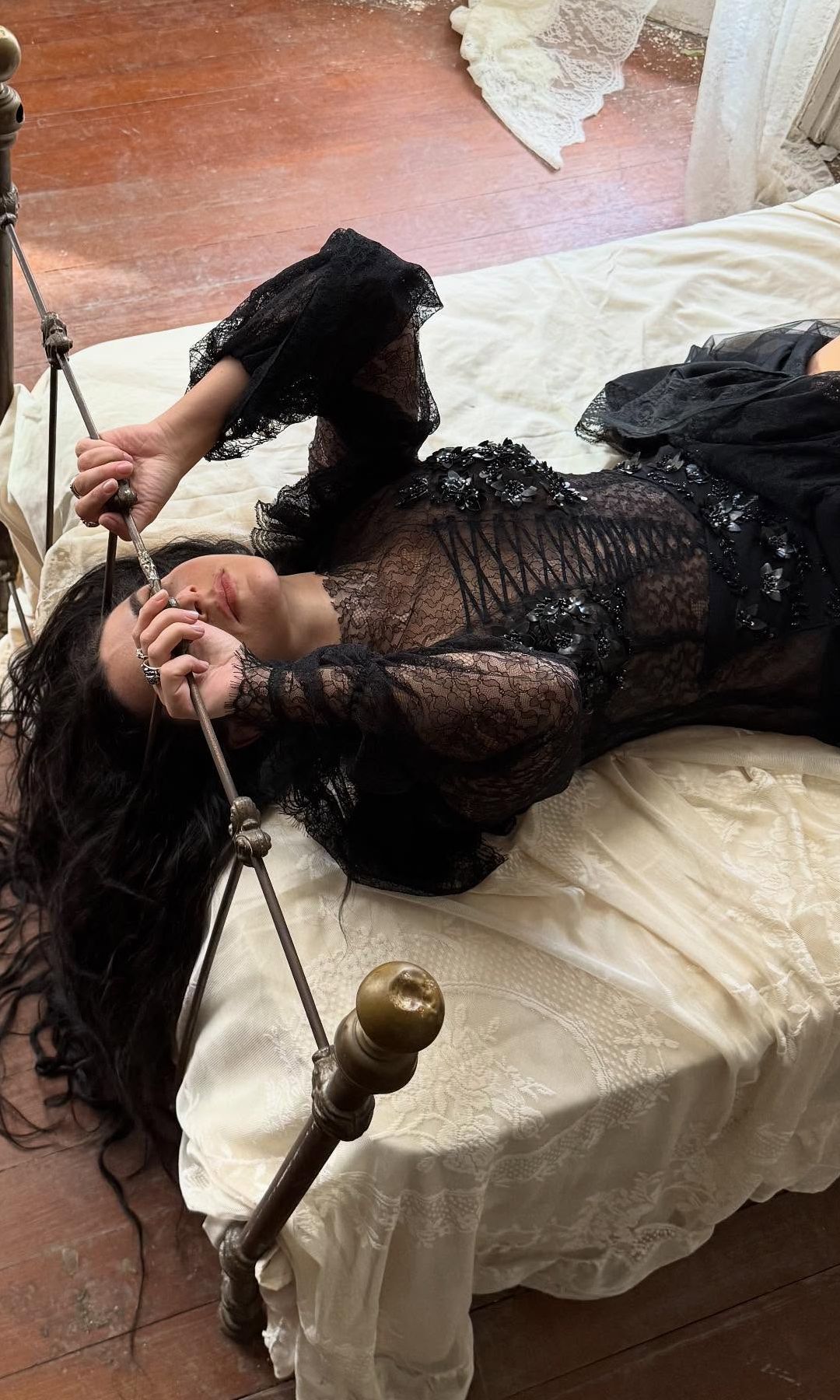 Charli XCX poses in a black lace dress for the Home music video