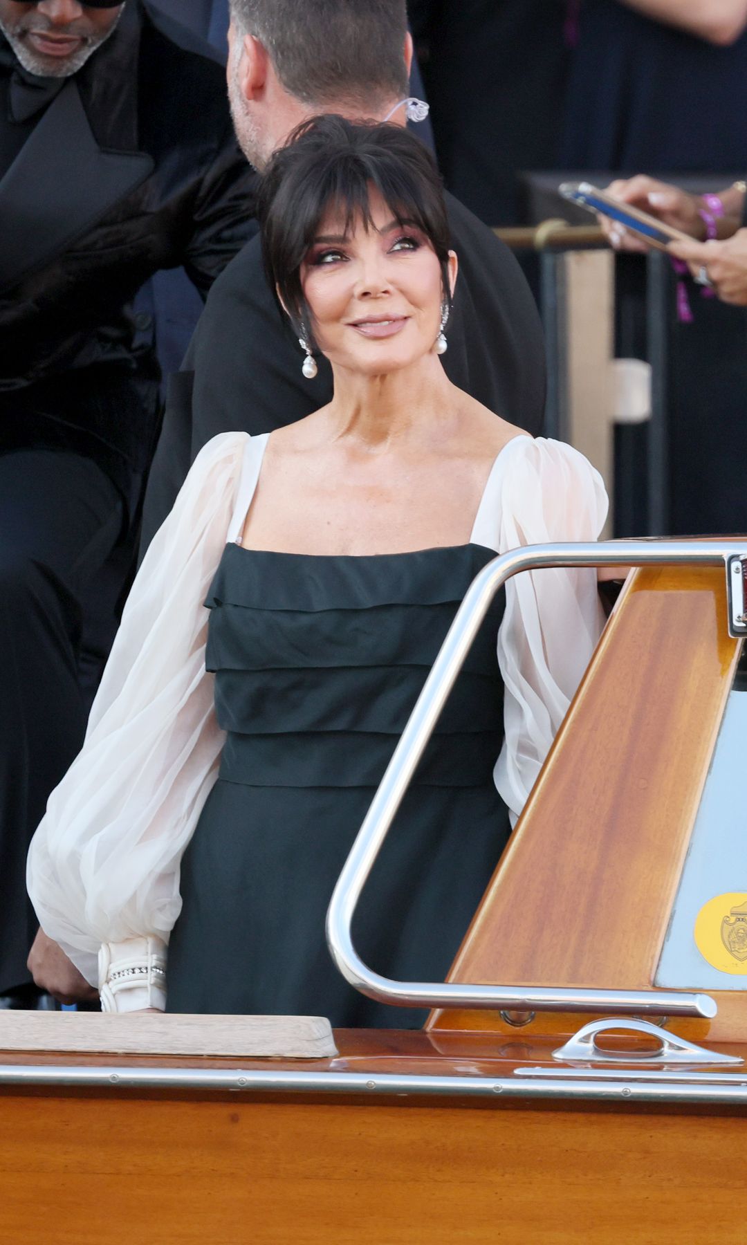 Jenner wore a black gown with ivory puff sleeves and pearl earrings, stepping onto a boat in Venice for Jeff Bezos' wedding celebrations.