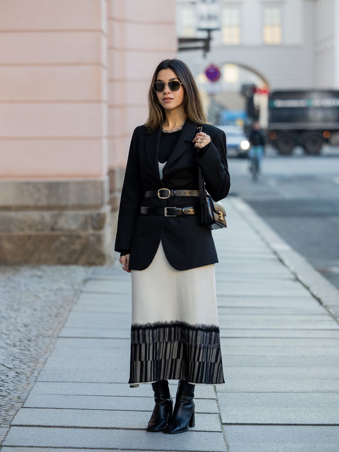 Bella Emar layers a double-belted blazer with a monochrome dress 