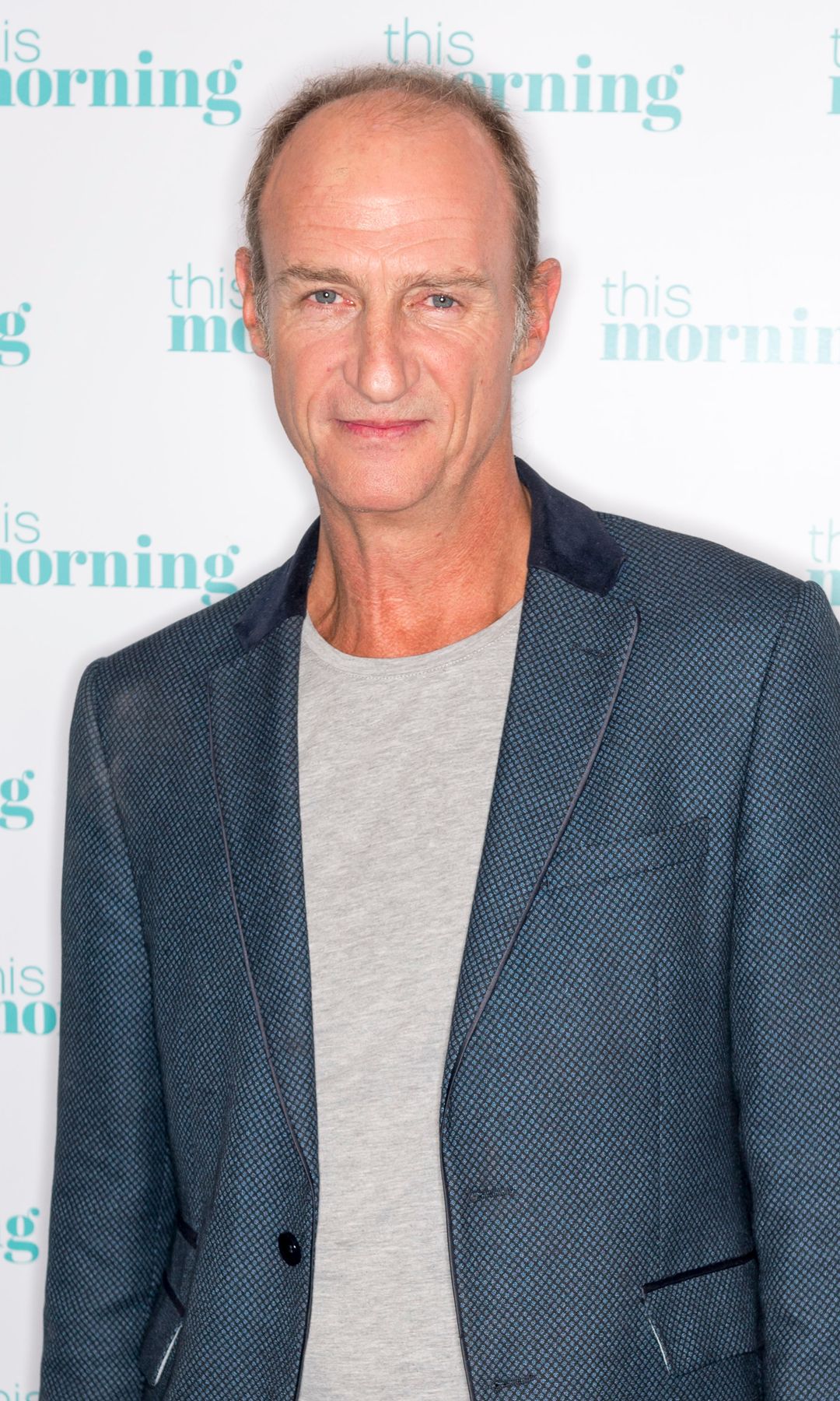 Stuart Bowman in a blue suit and grey shirt