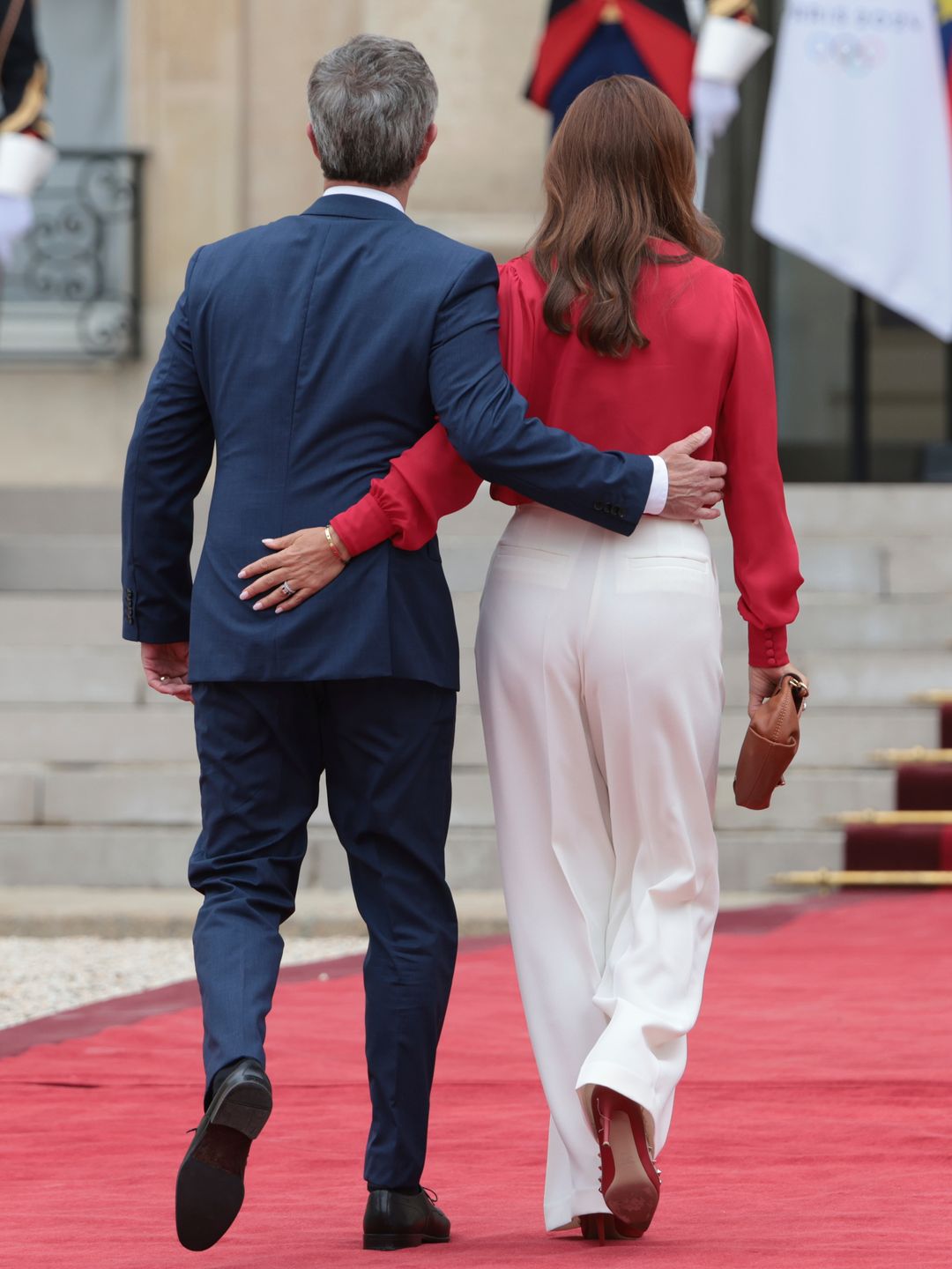 king frederik and queen mary walking on red carpet in paris