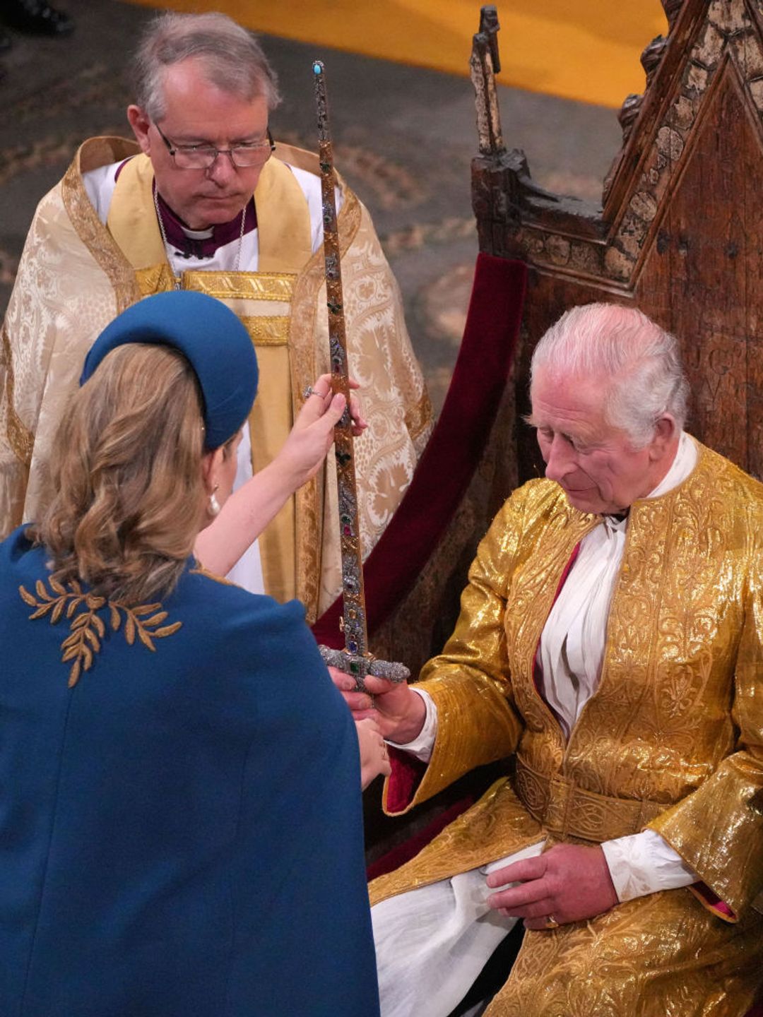 Lord President of the Council, Penny Mordaunt, presenting the Sword of State, to King Charles III during his coronation ceremony in Westminster Abbey