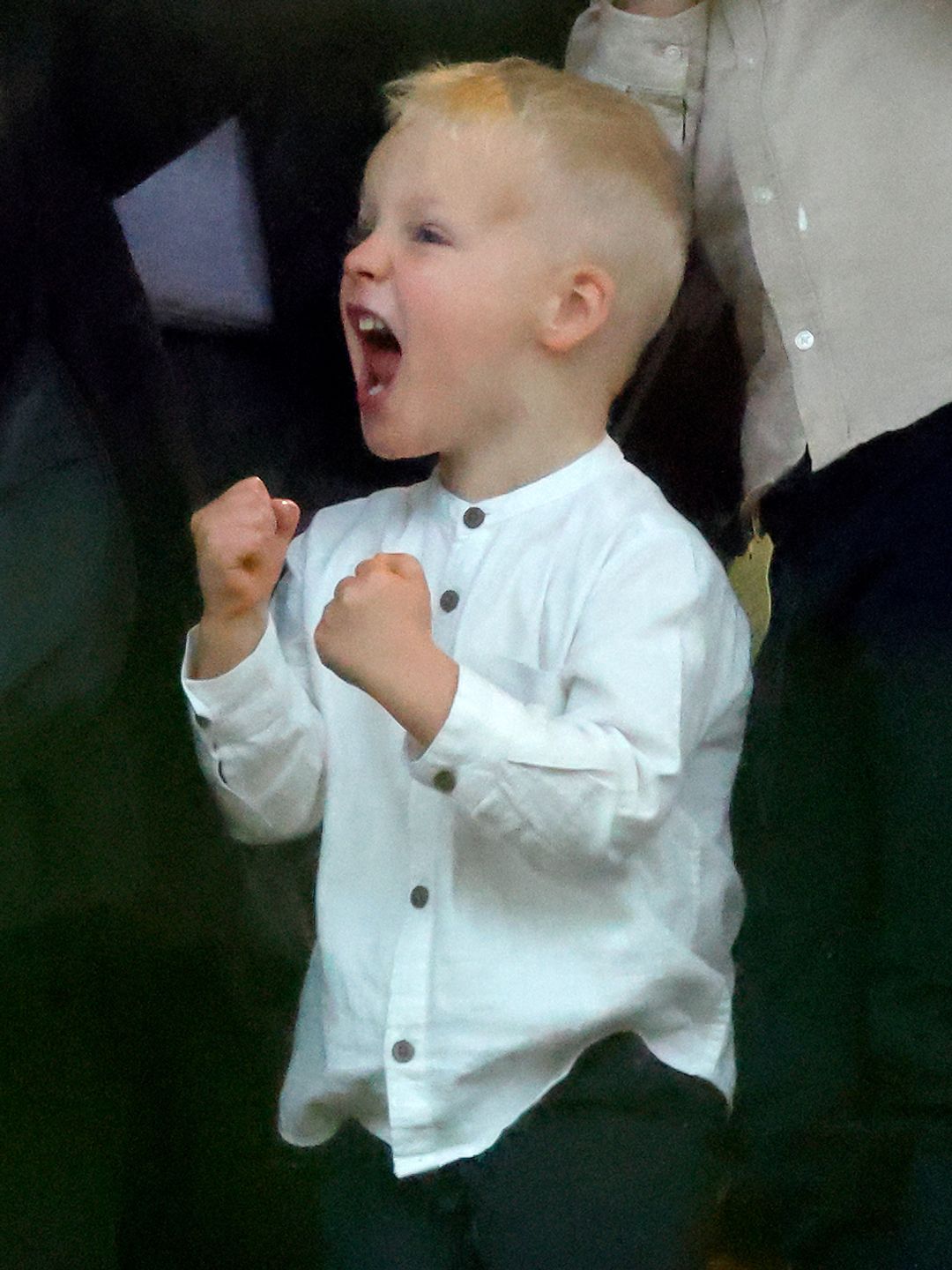 young boy cheering 