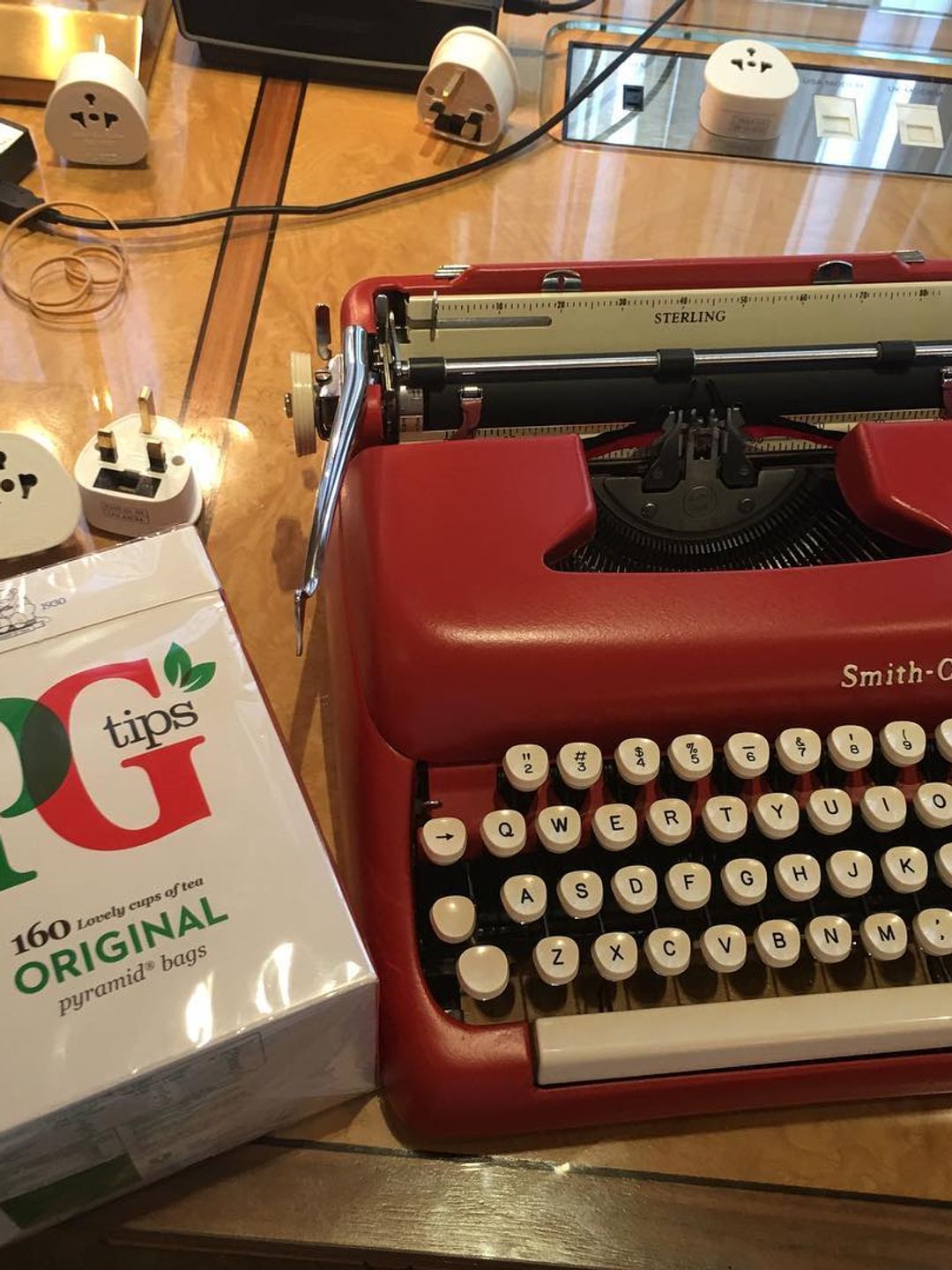 typewriter on table with box of teabags