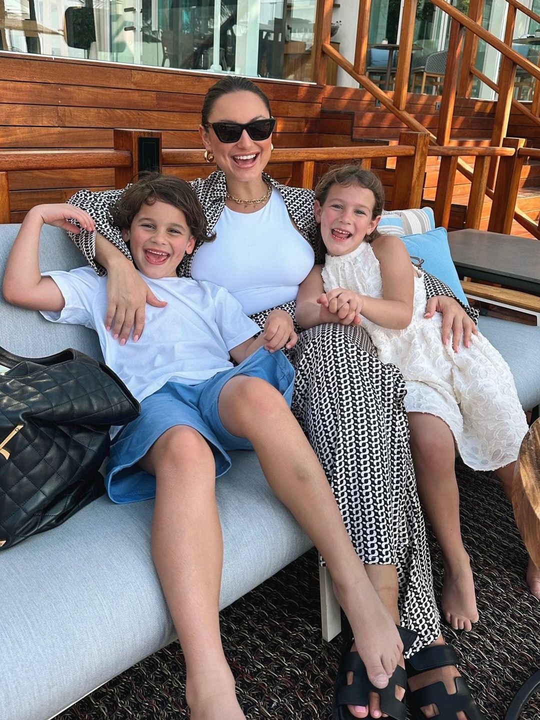 Sam Faiers in sunglasses as she cuddles her two eldest kids in Dubai