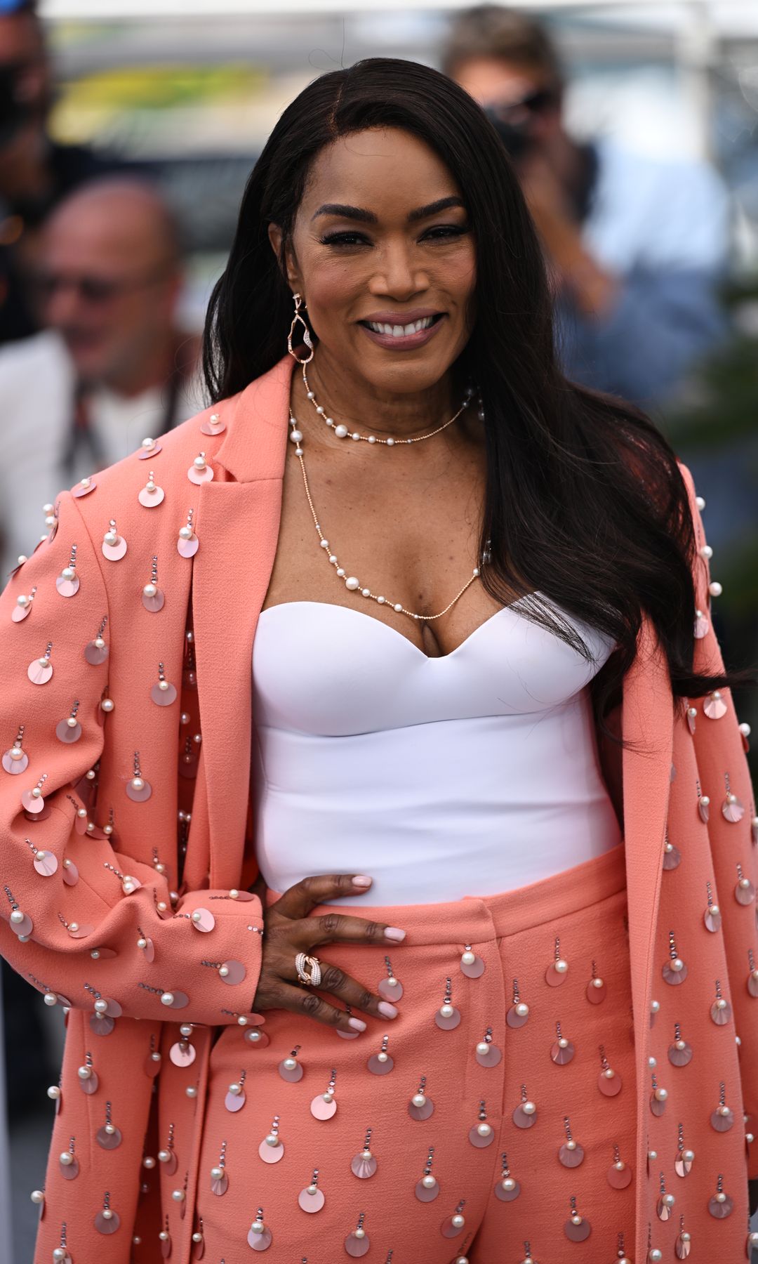 Angela Basset in a salmon blazer and white dress