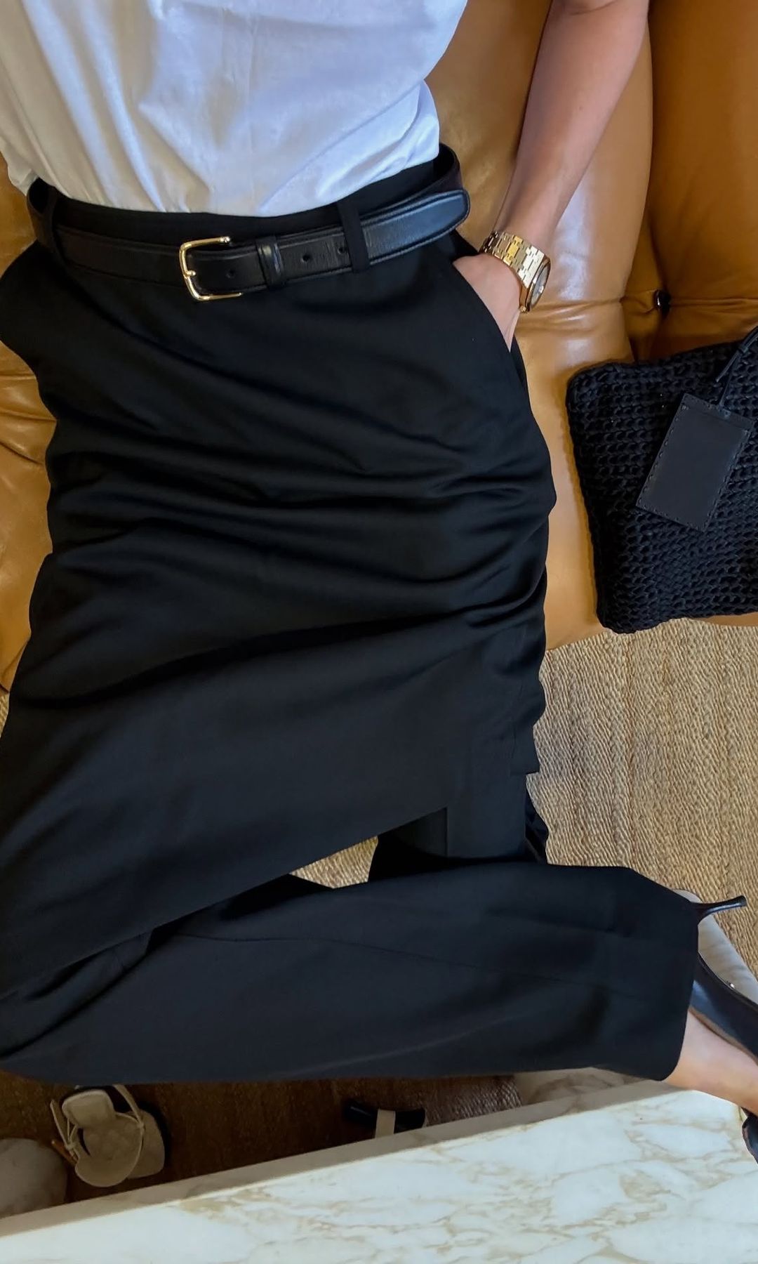 Elsa Hosk wears a black pair of trousers with heels and a plain white tee