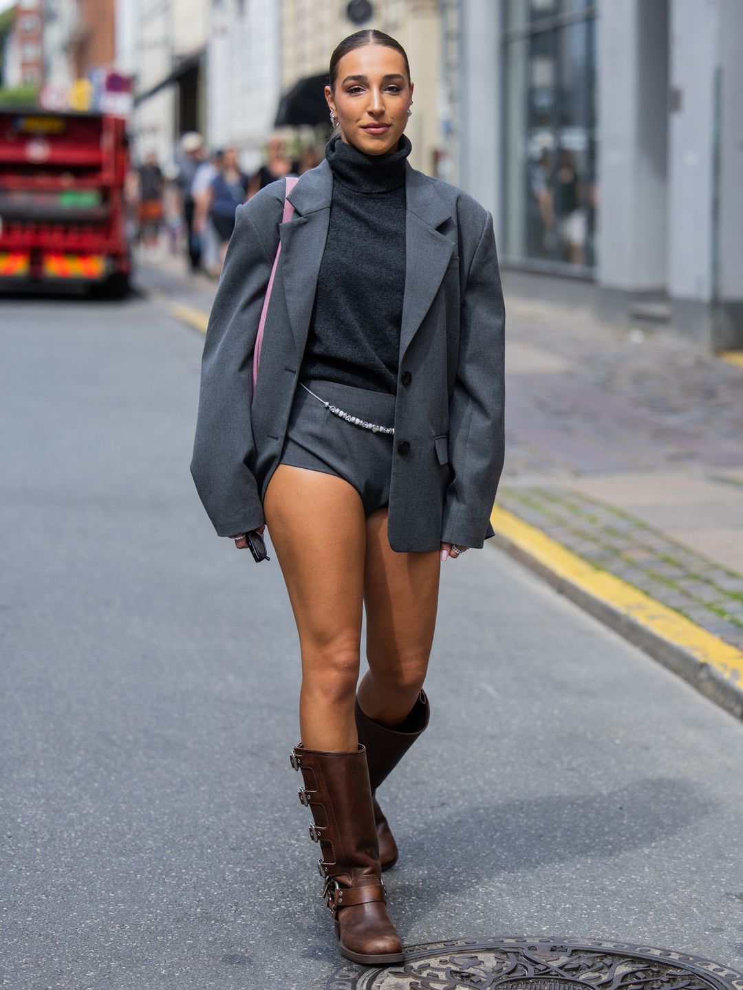 Ginevra Mavilla wearing grey shorts paired with an oversized blazer and turtleneck.