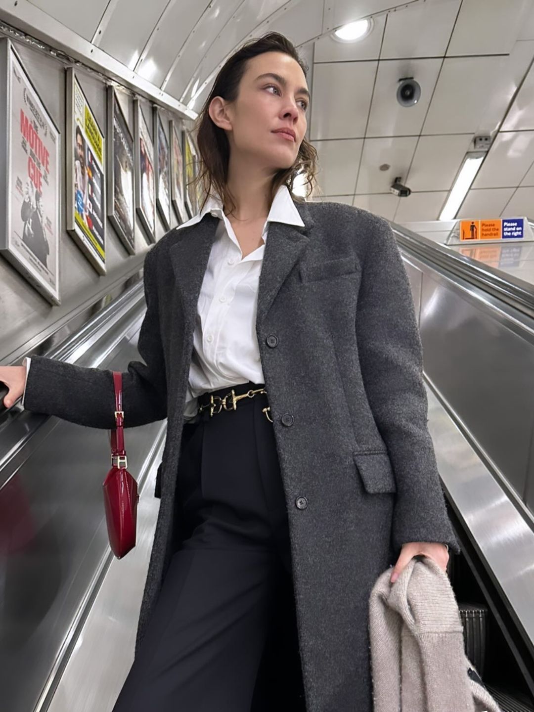 Alexa Chung wears a grey coat, white shirt and trousers for NYE 2023