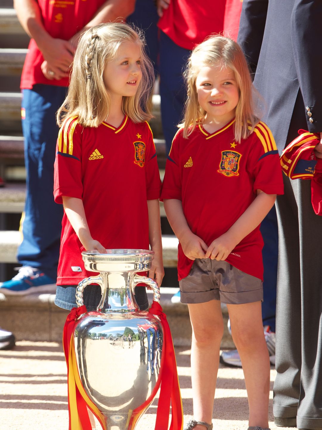 two girls wearing spanish football jerseys