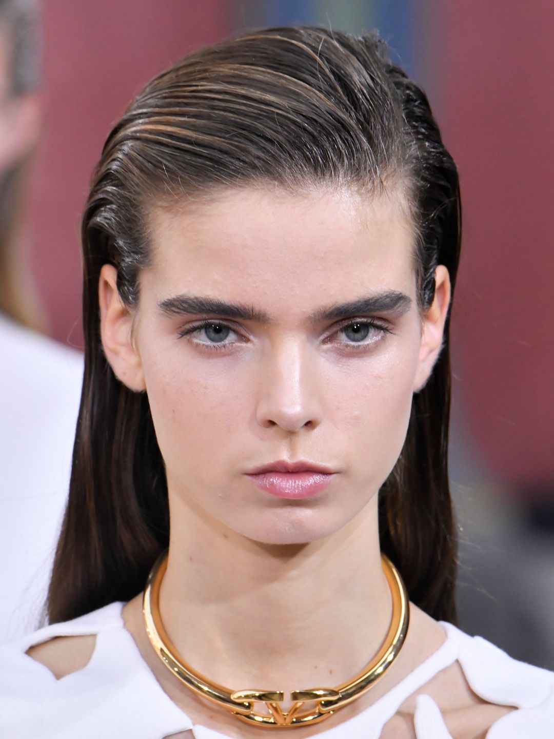 Model with slicked-back side parting hair at Valentino SS24 