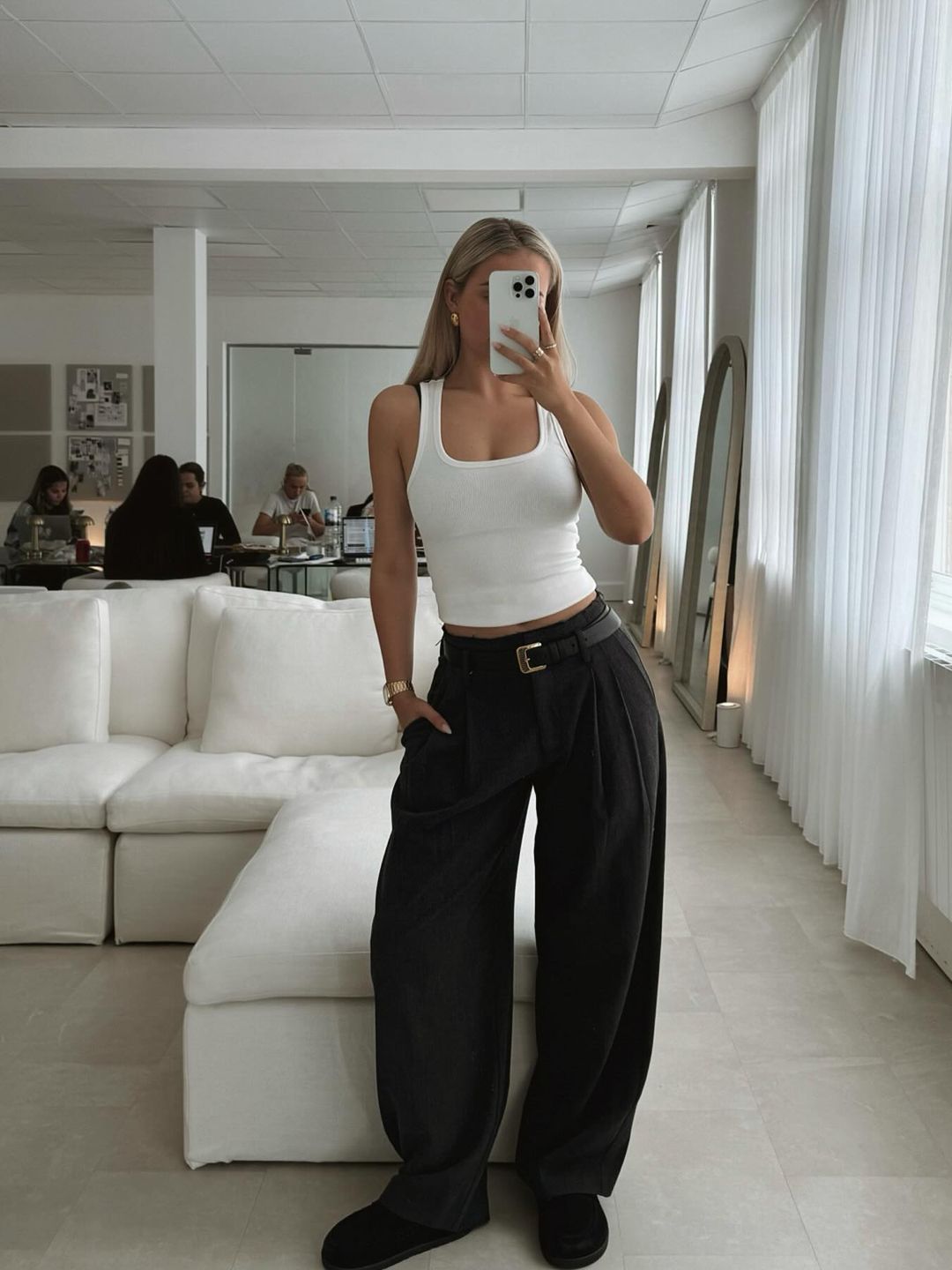 Molly-Mae Hague poses in her office wearing black trousers and a tank top