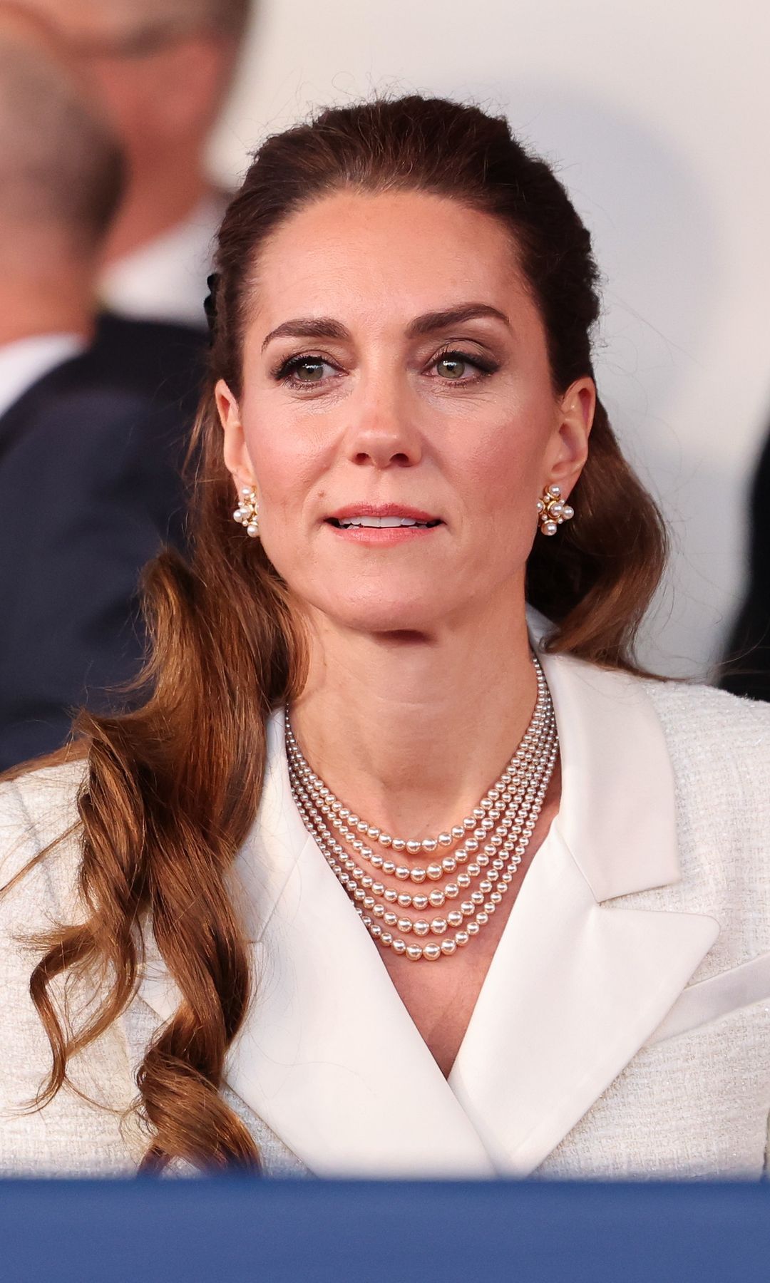 Kate Middleton sitting in a white outfit