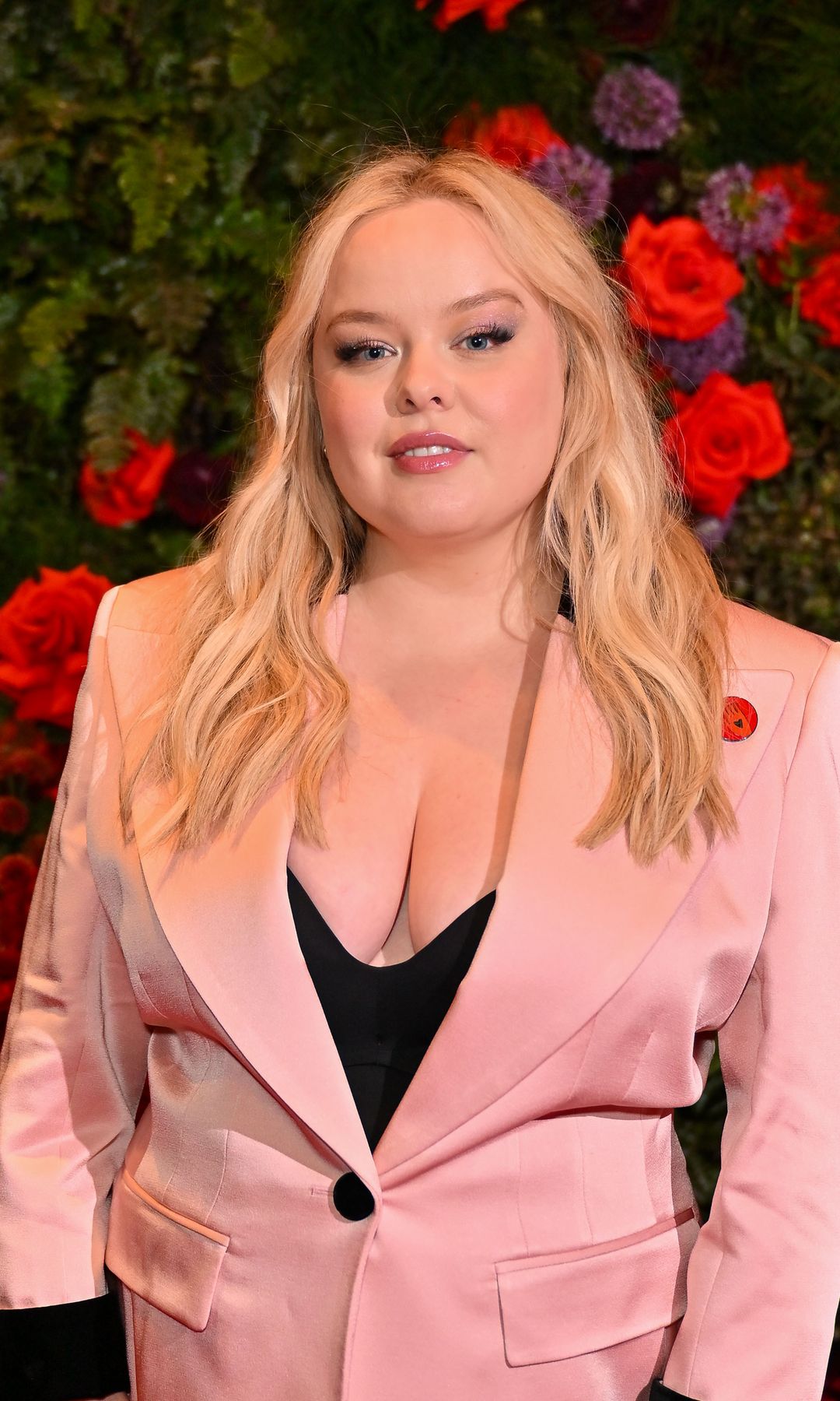 Nicola Coughlan attends an event hosted by British Vogue and Netflix to celebrate the BAFTA Television Awards at Dovetale at 1 Hotel on May 8, 2025 in London, England in a pink suit