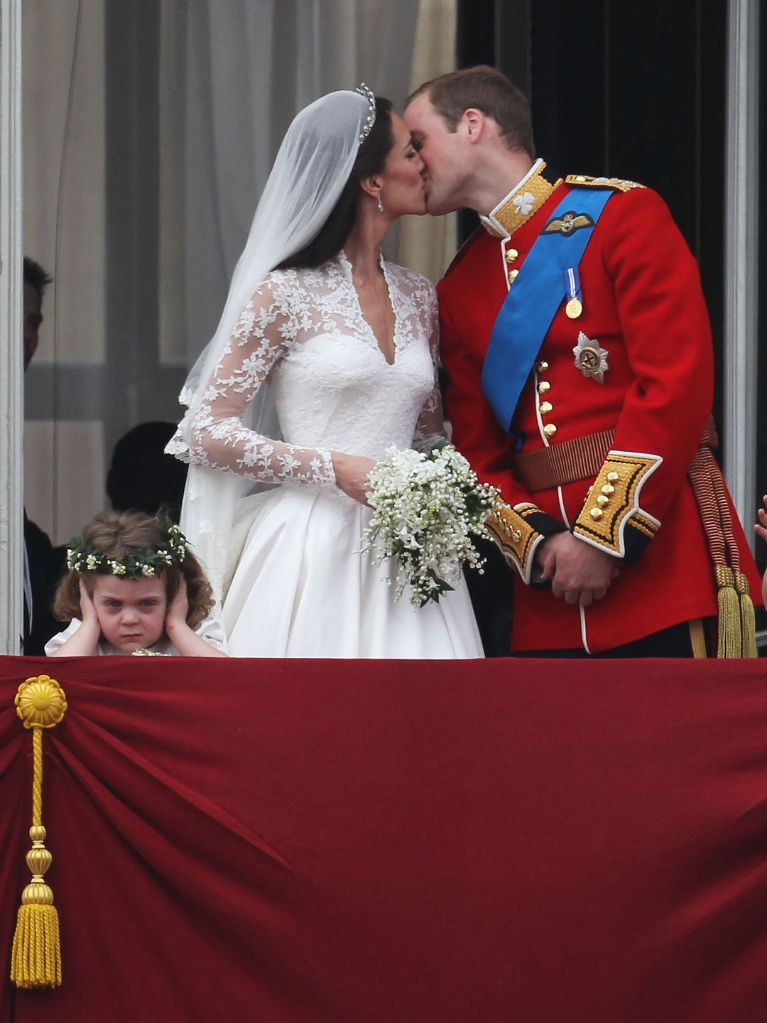 Grace van Custem covering her ears at the Prince and Princess of Wales' royal wedding kiss 